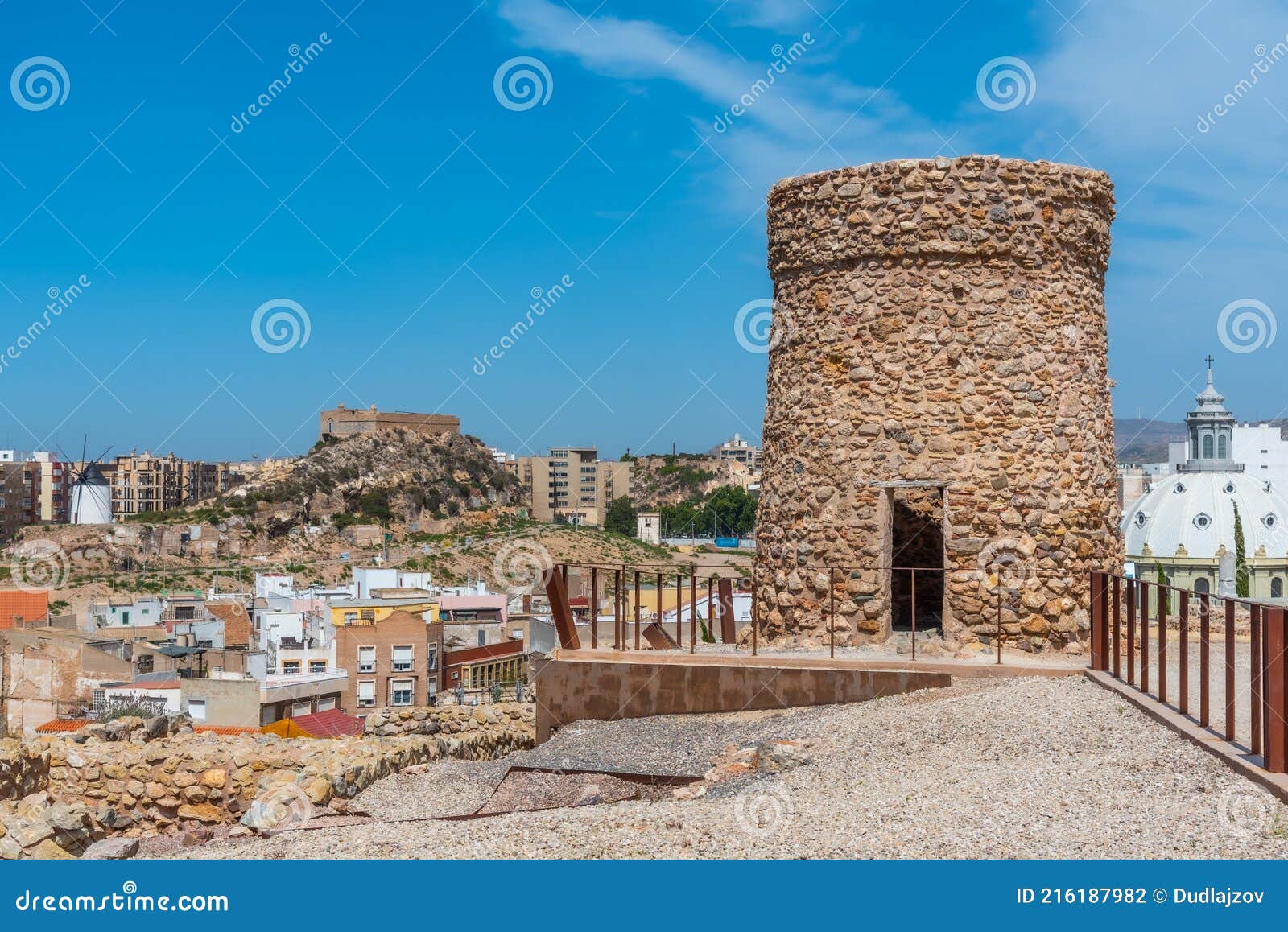 windmill and fortress on monte sacro viewed from archeological park on cerro del molinete in cartagena, spain