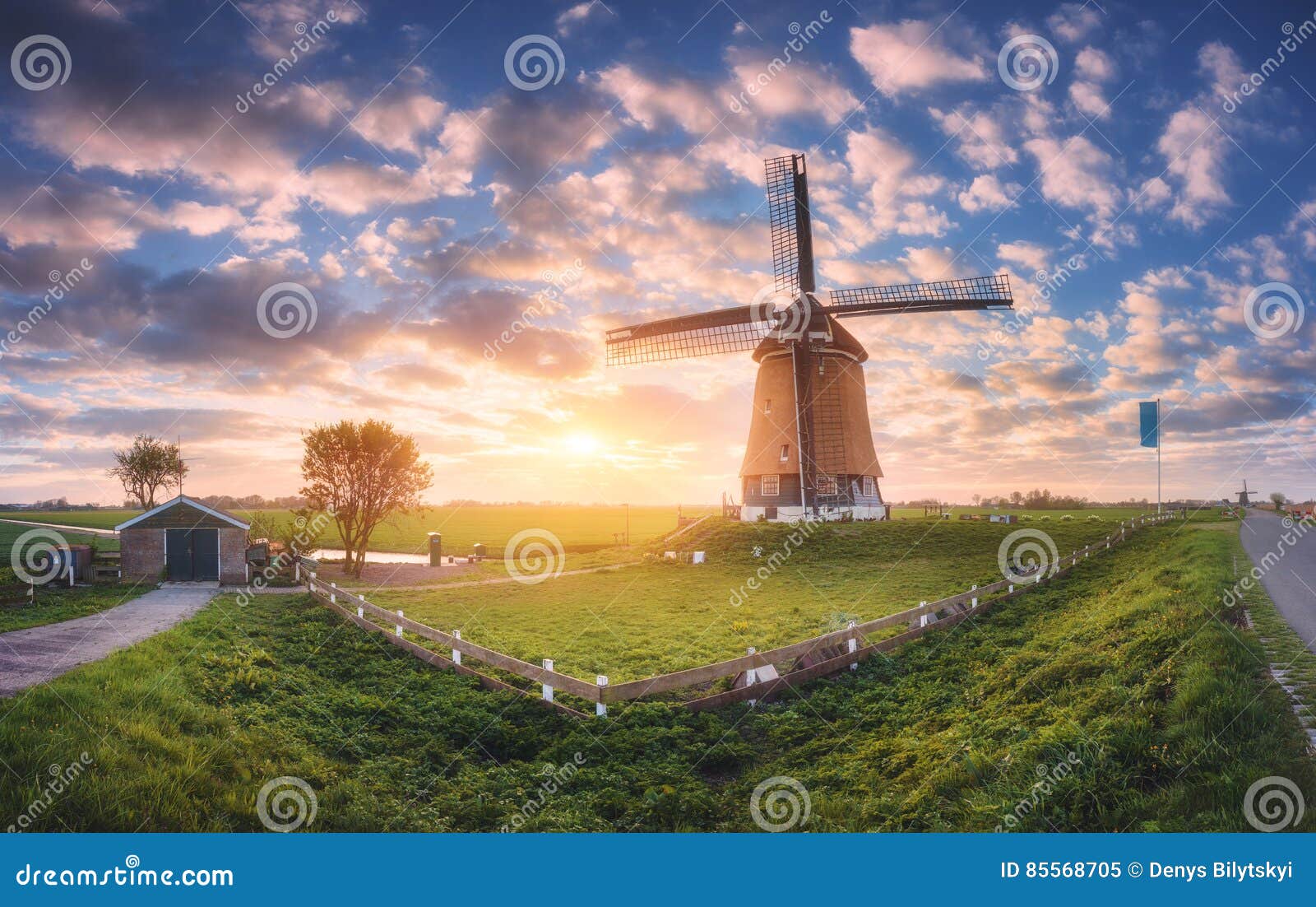 windmill at sunrise in netherlands. spring panoramic landscape