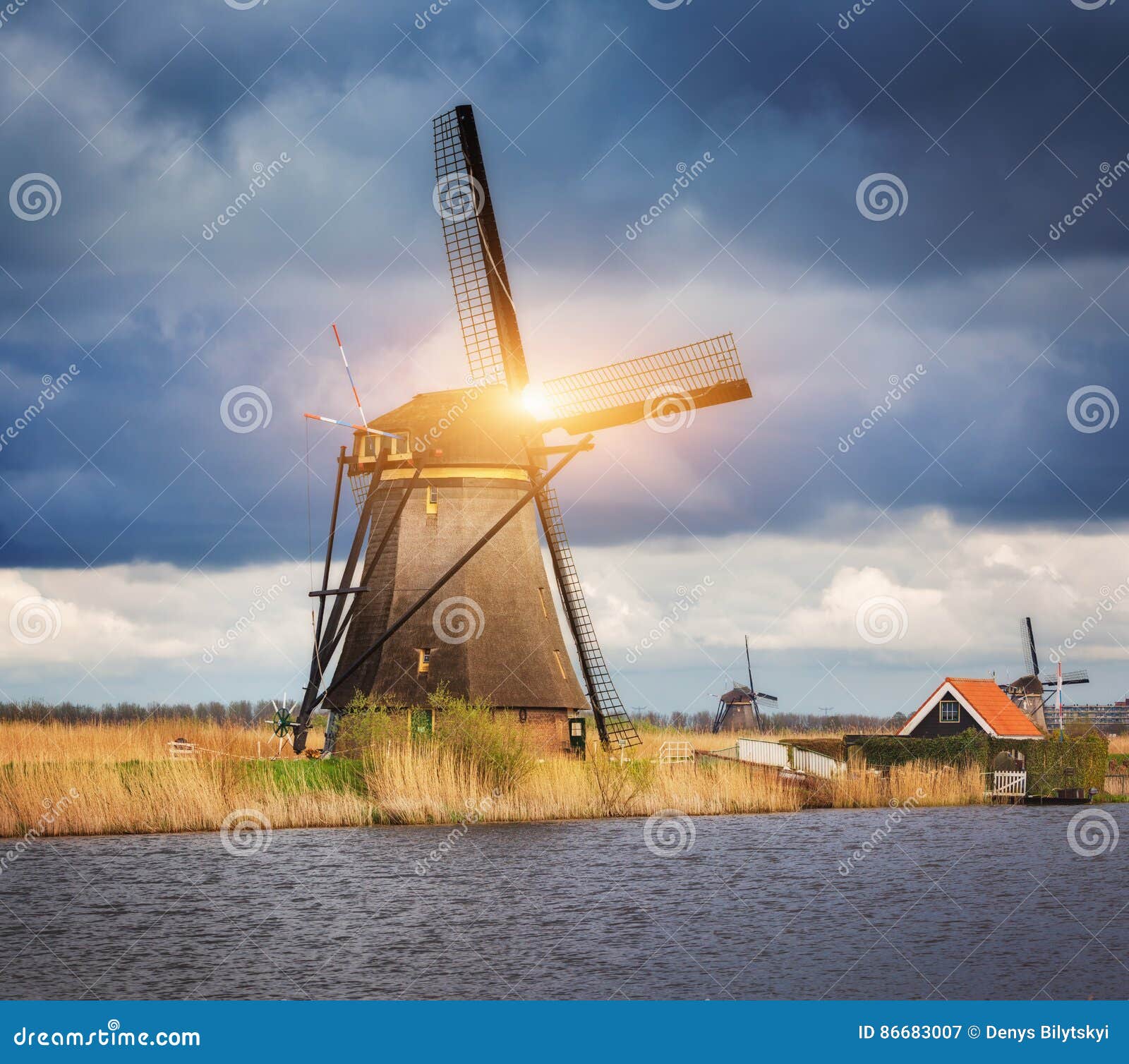 Windmills Against Cloudy Sky at Sunset in Kinderdijk, Netherland Stock ...