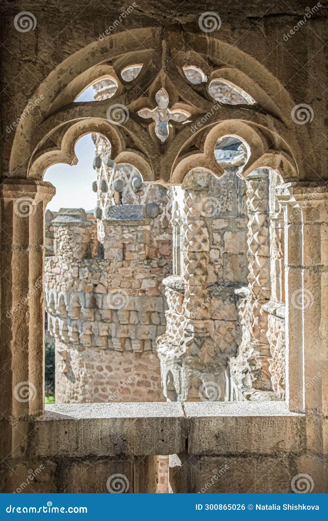the window of the ancient medieval castle in the gothic style from which can see the beautiful carved towers of the castle.