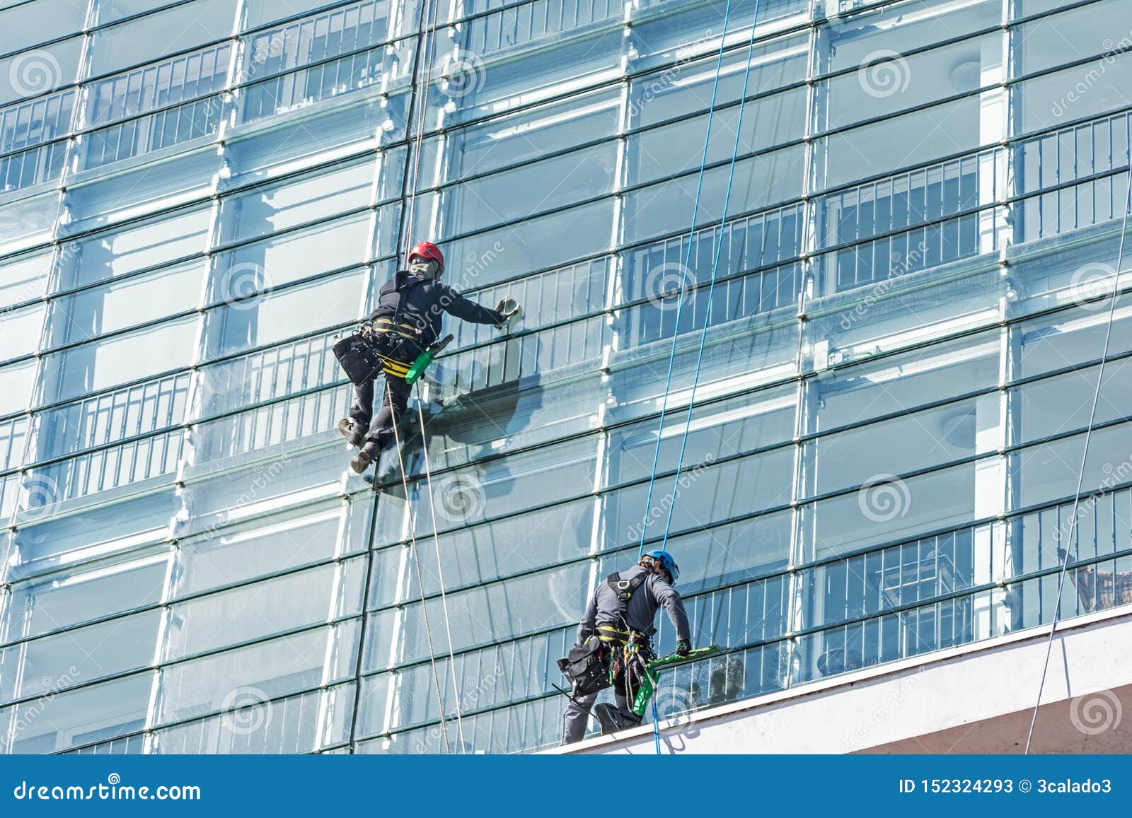 Window Cleaners on Glass Facade of a Skyscraper Editorial Stock Photo