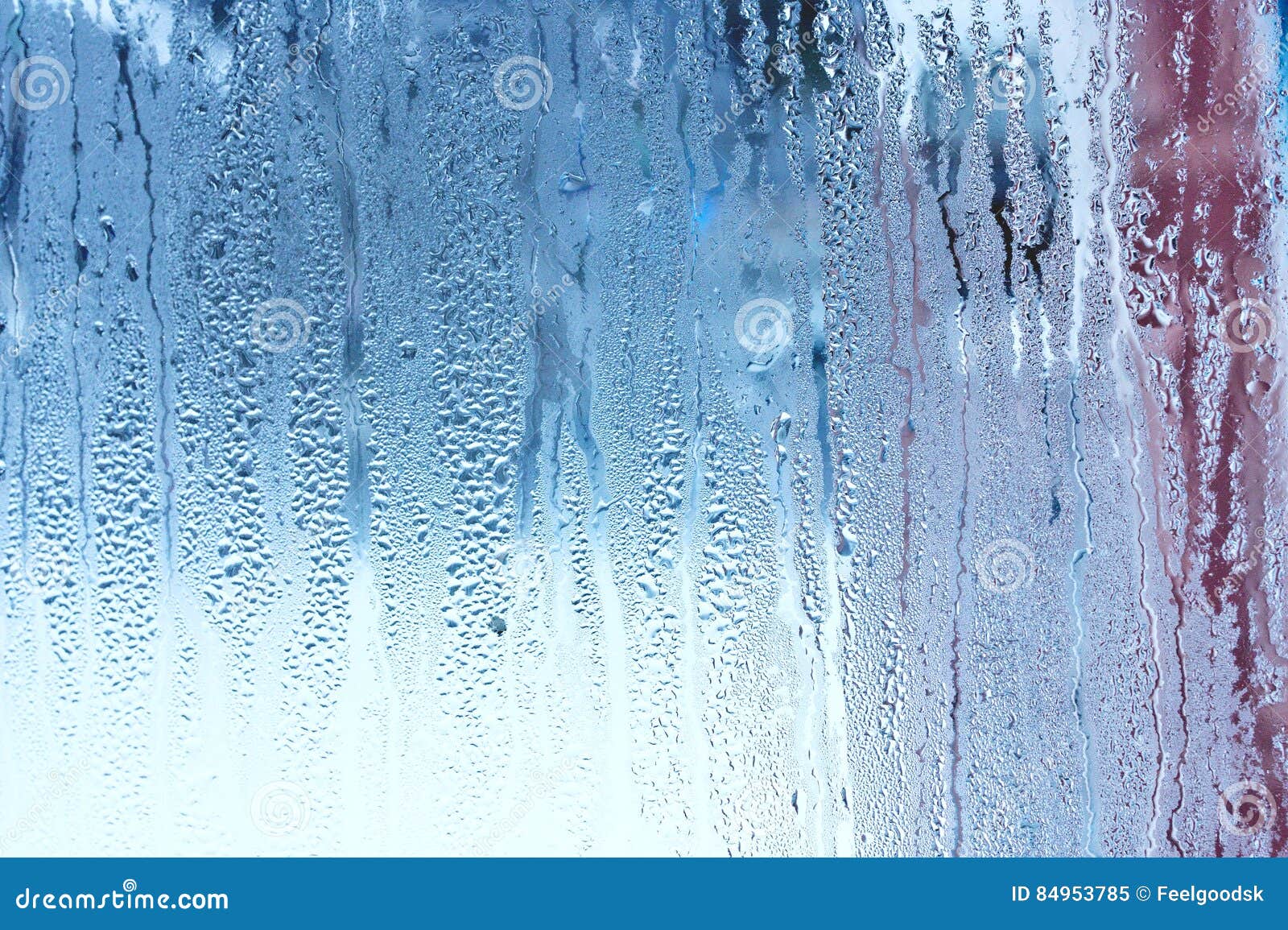window glass with condensation, high humidity in the room, large water droplets, cold tone
