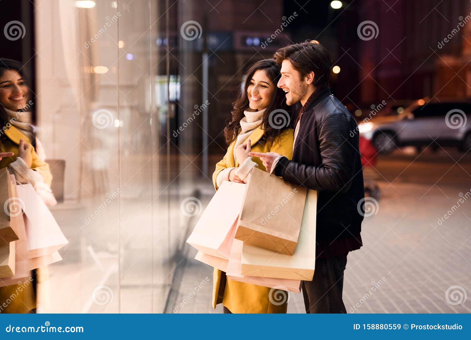 window shopping. young couple looking at showcase