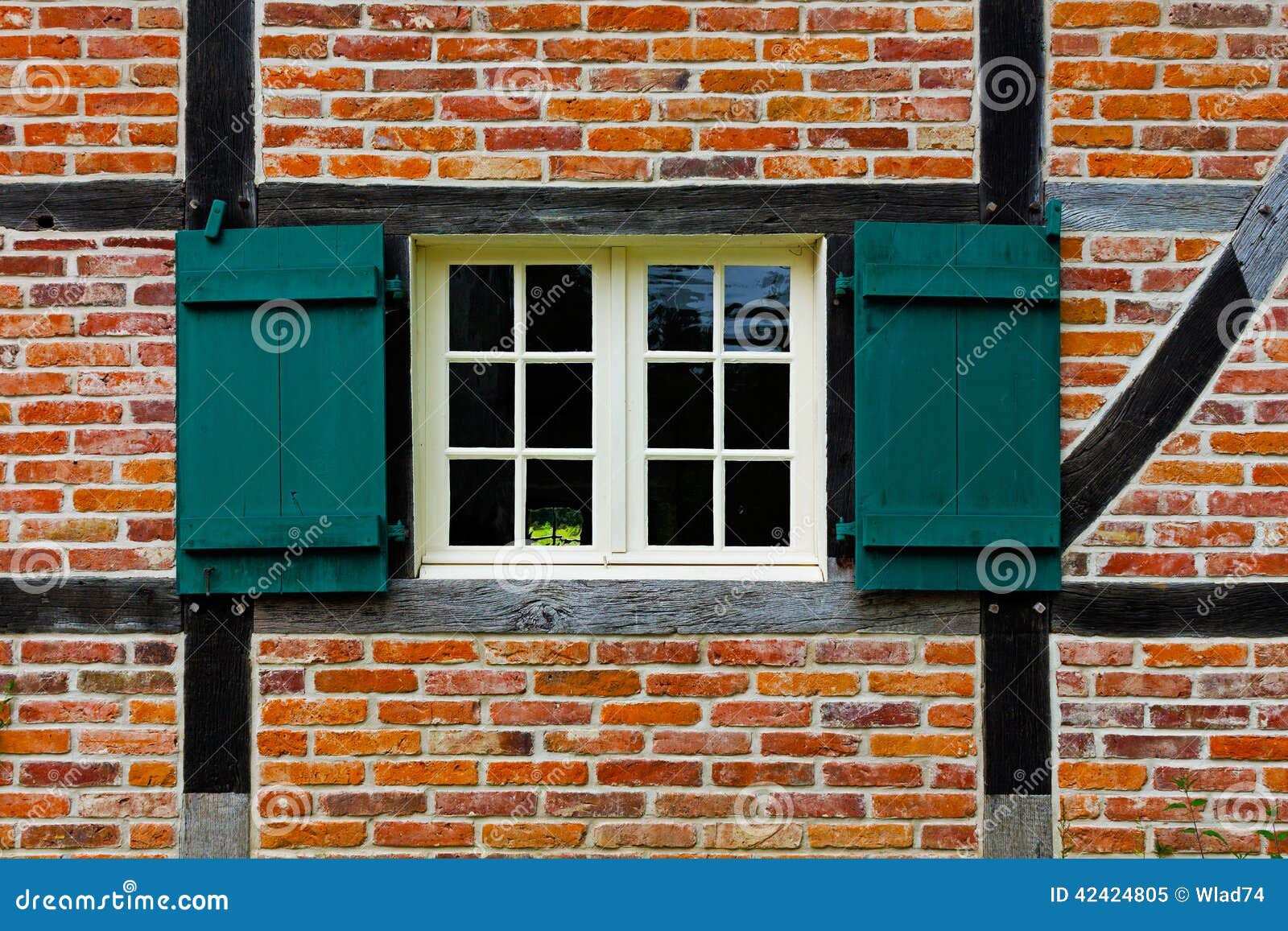 Window with Shutters in Brick Wall of Half Timbered House Stock Image