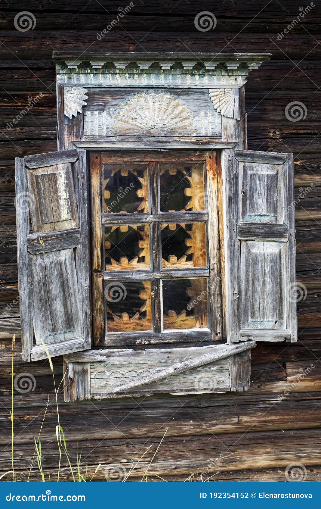 windows with carved frames and shutters in village houses