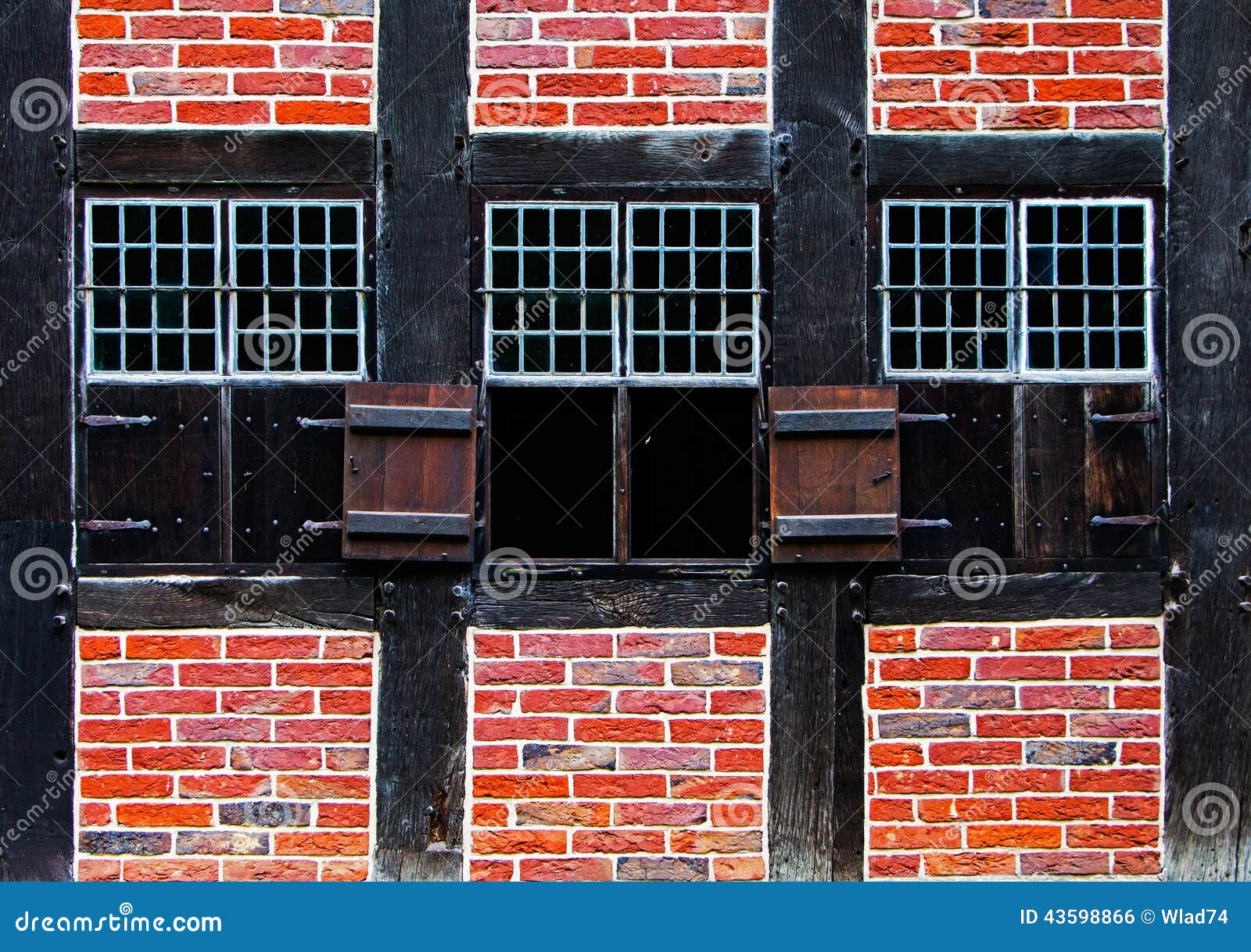 Windows with Shutters in Brick Wall of the Half Timbered House Stock