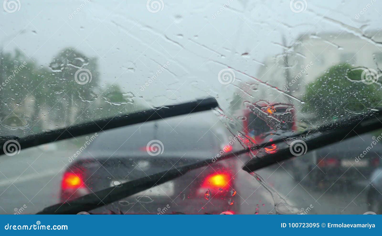 Windscreen Wipers Cleaning Windshield Glass on Deep Rainy Day Stock