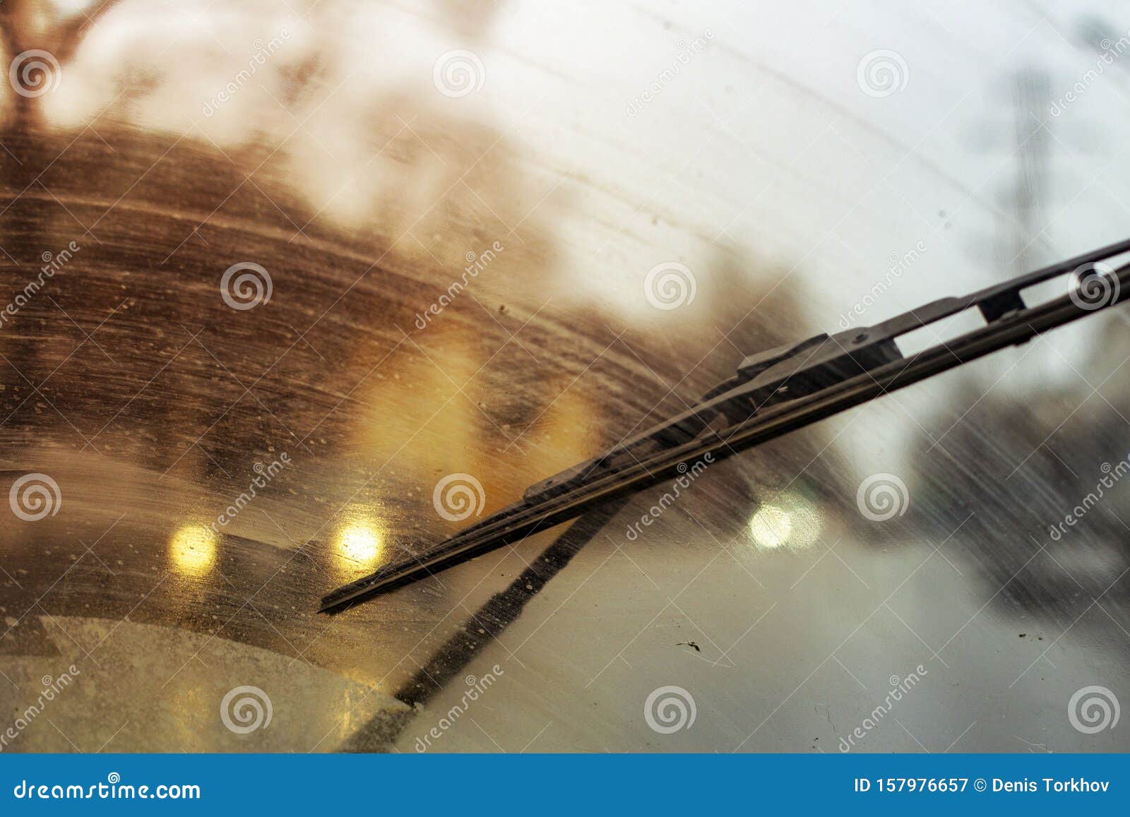windshield wipers from inside of car, season rain, front and background blurred with bokeh effect