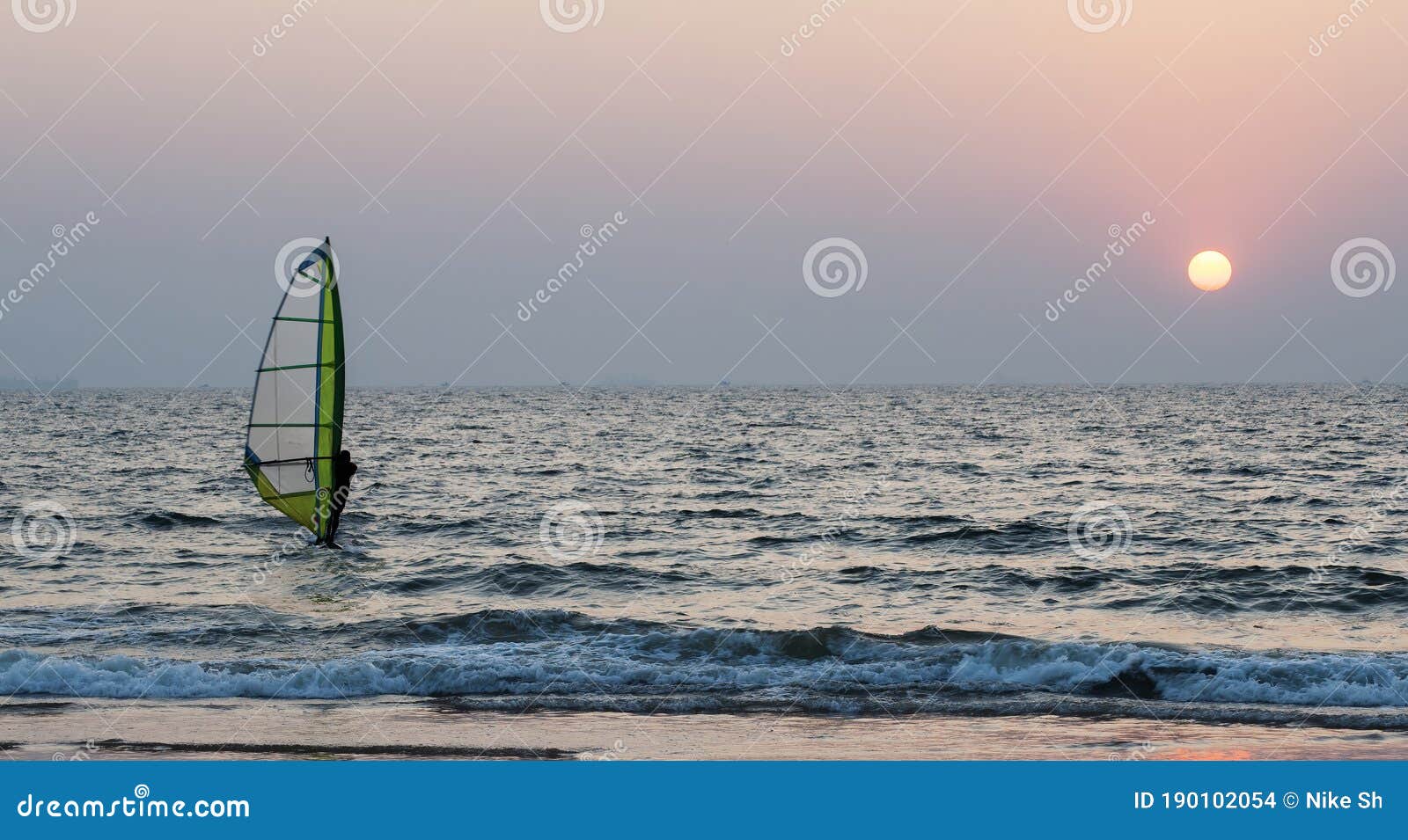 Windsurfing at sunset stock photo. Image of outdoors 190102054