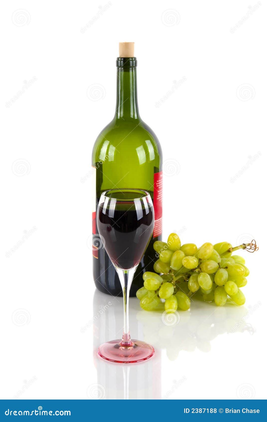 Wine bottle, a glass of red wine, and grapes