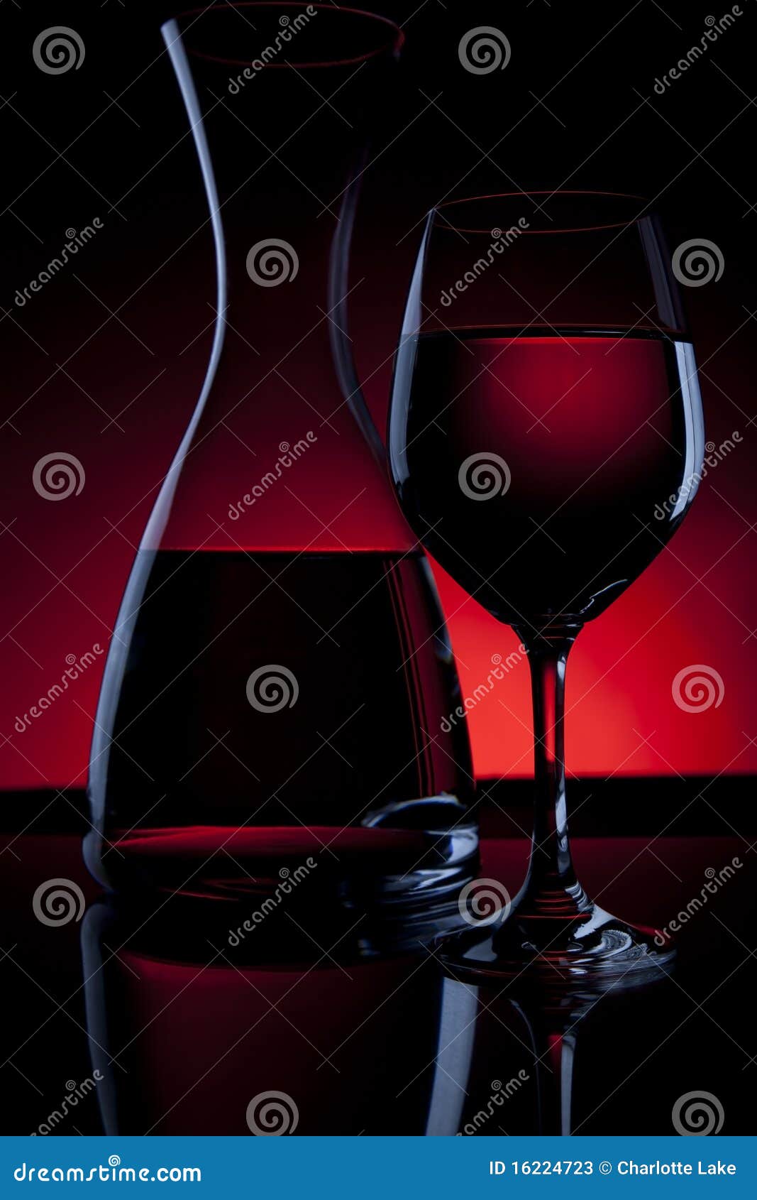 wine carafe and glass on red