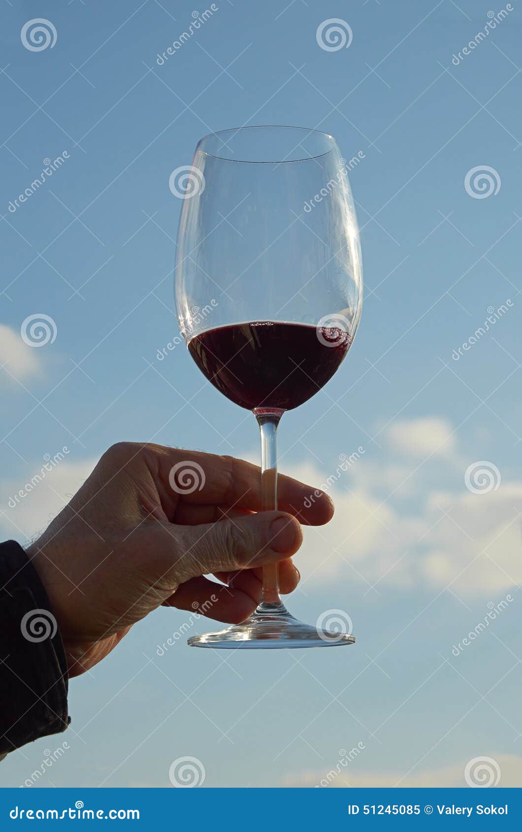 Wine glass against the blue sky.