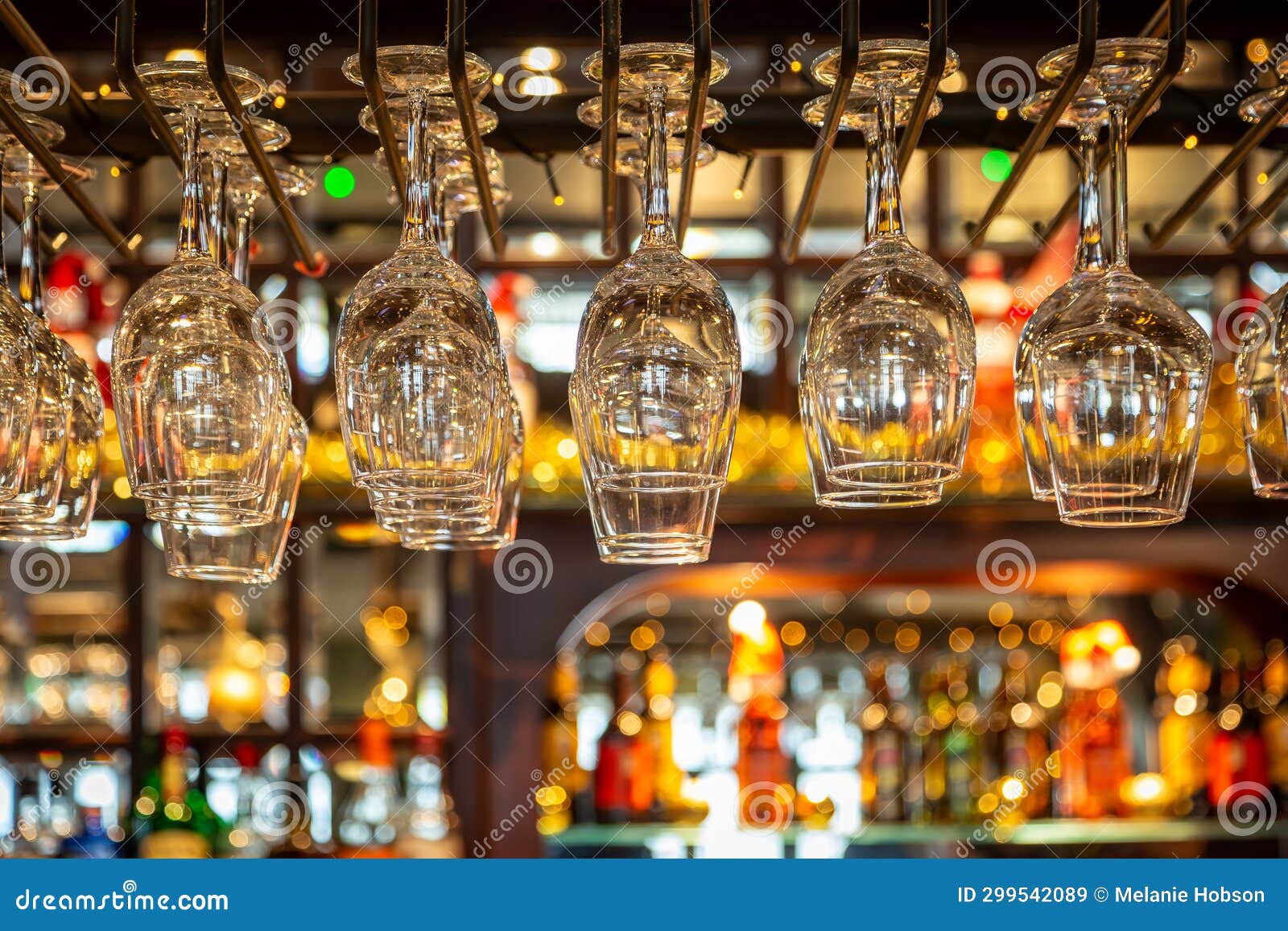 Wine Glasses Hanging Over a Bar, with a Shallow Depth of Field Stock