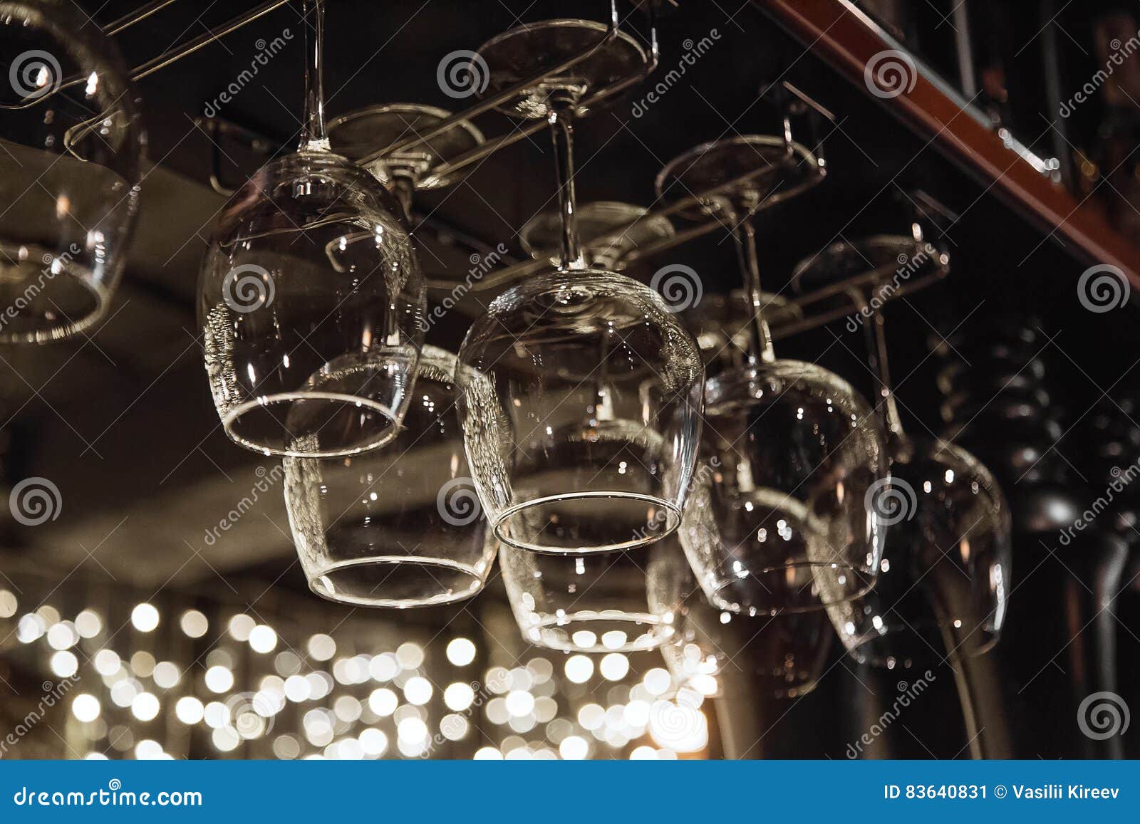 Wine Glasses in Shelf Above a Bar Rack in Restaurant Stock Image