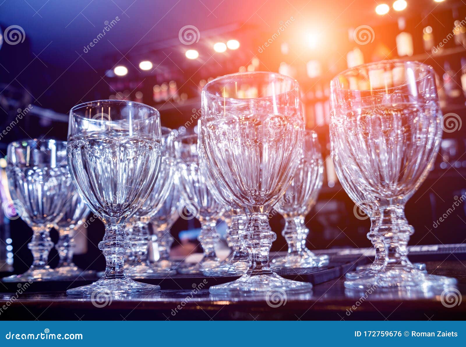 Wine and Martini Glasses in Shelf Above a Bar Rack in Restaurant. Stock