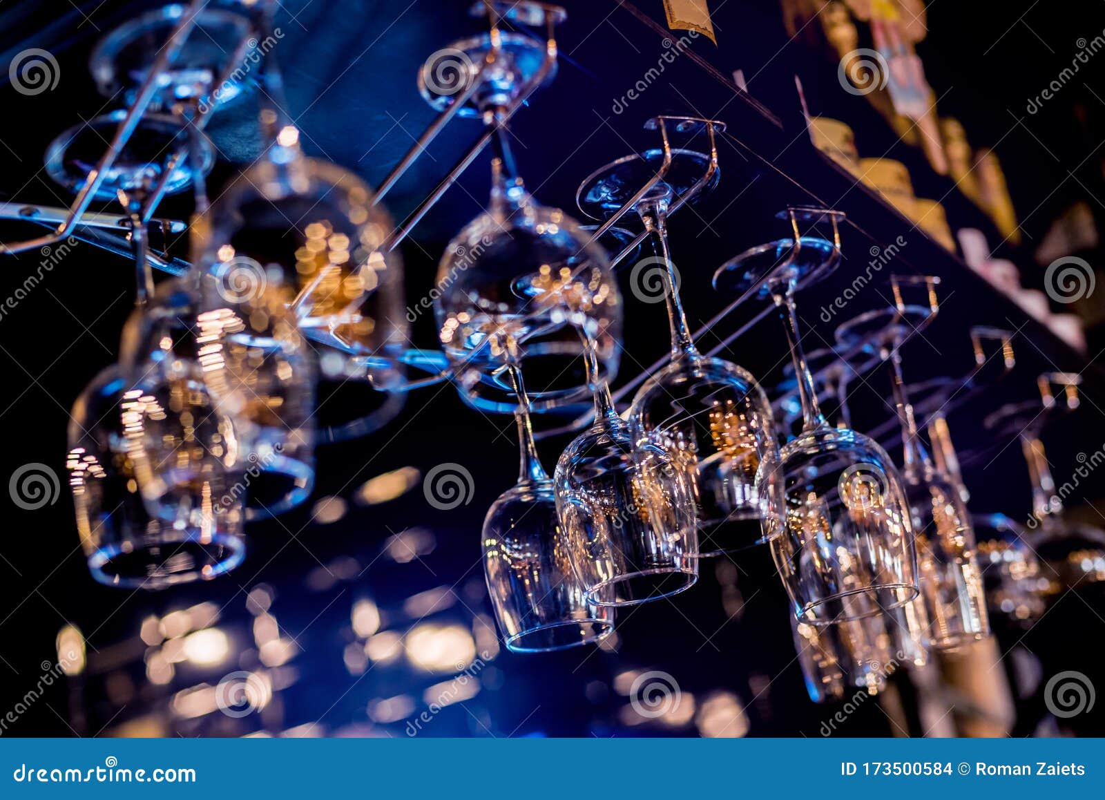 Wine and Martini Glasses in Shelf Above a Bar Rack in Restaurant. Stock