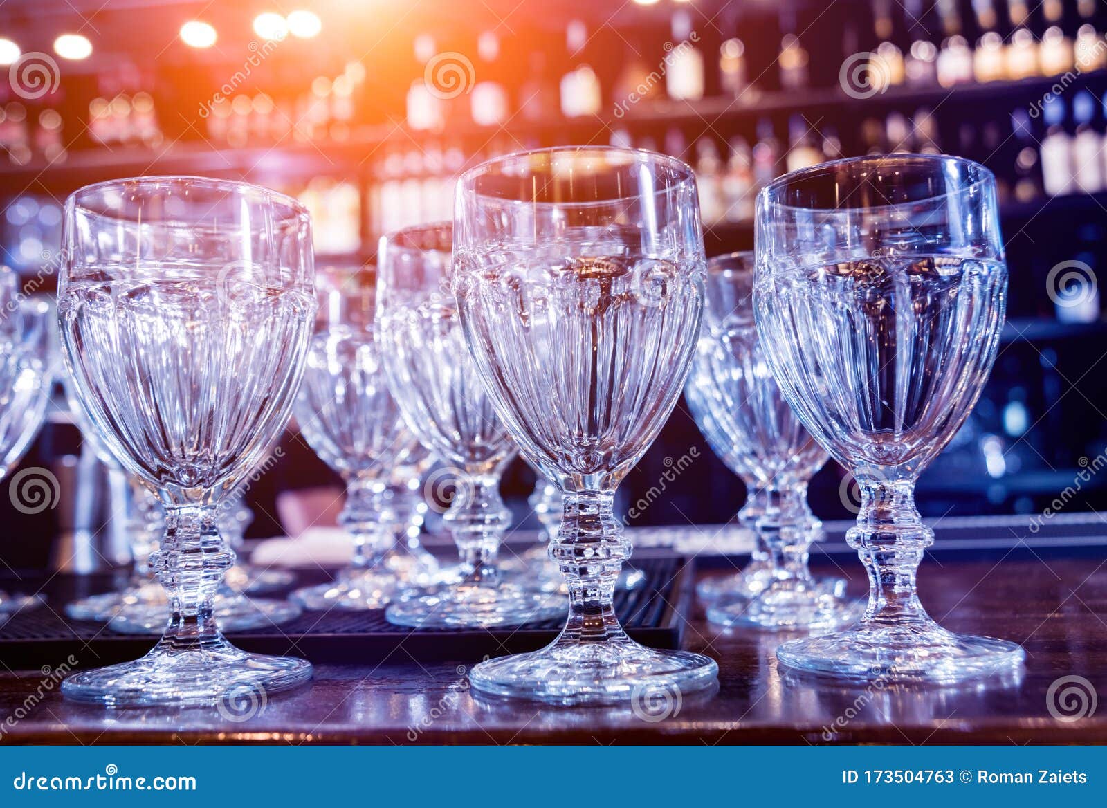 Wine and Martini Glasses in Shelf Above a Bar Rack in Restaurant. Stock