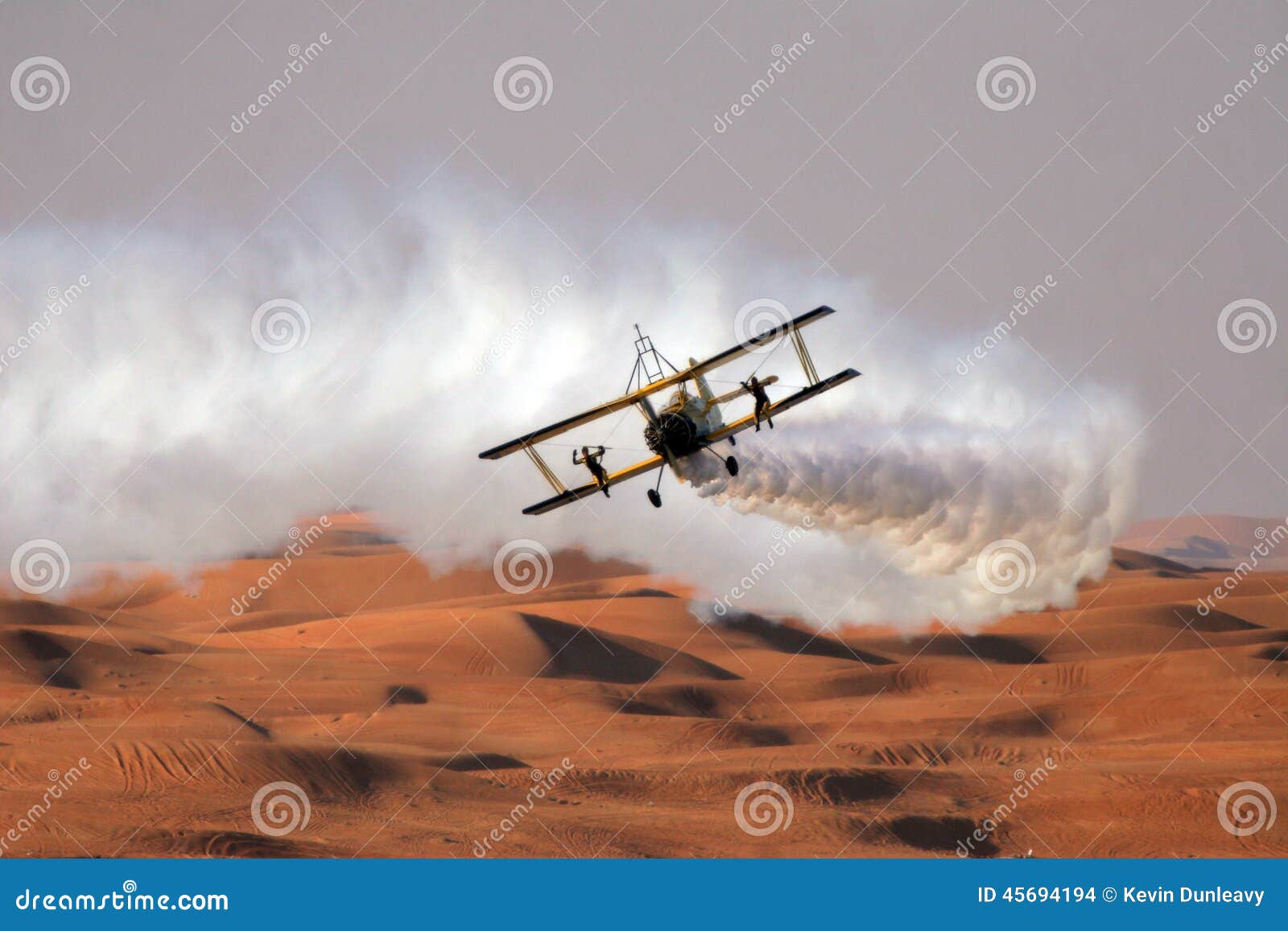 wing walkers on a bi-plane over the desert