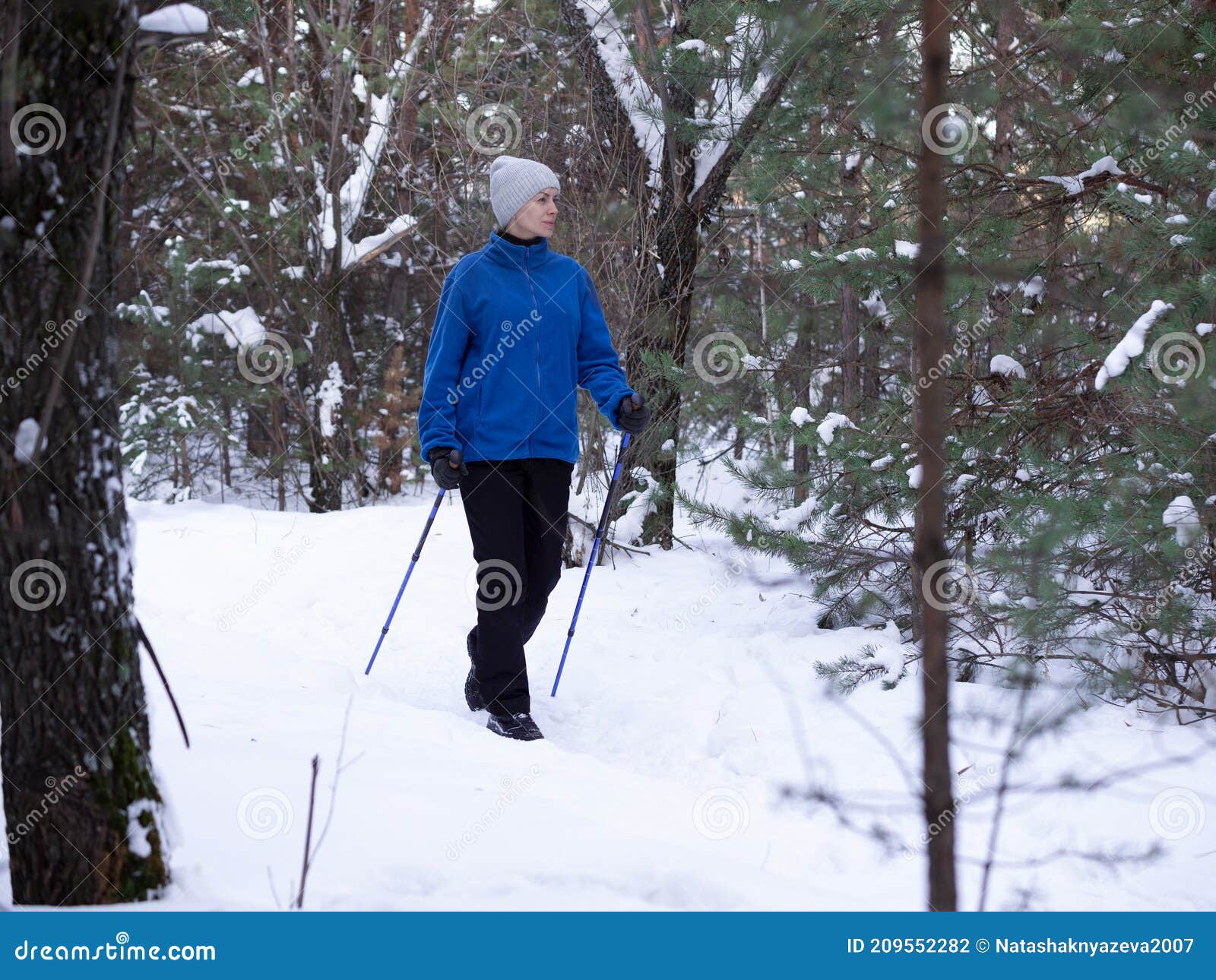 Winter Activity. Adult Caucasian Woman in Blue Warm Sportwear Does ...