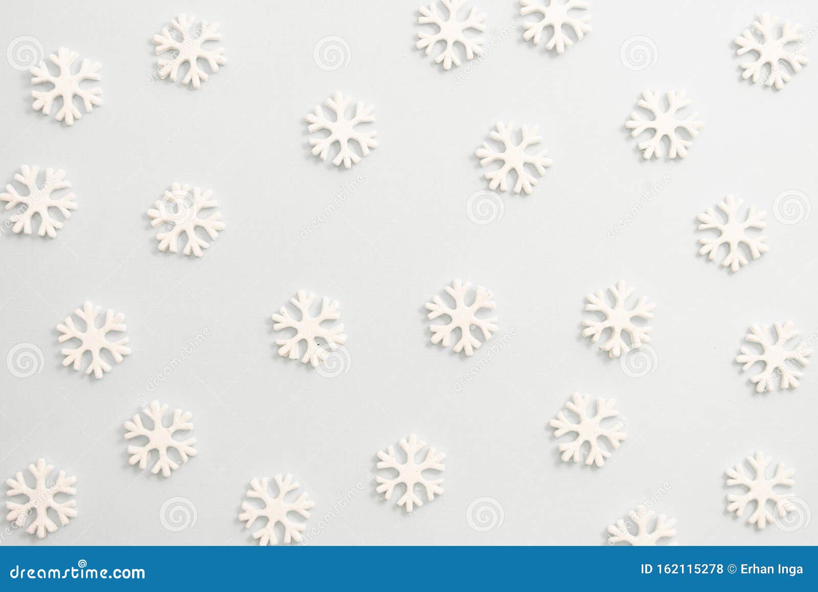 winter background, white snowflakes over white board. abstract christmas winter texture