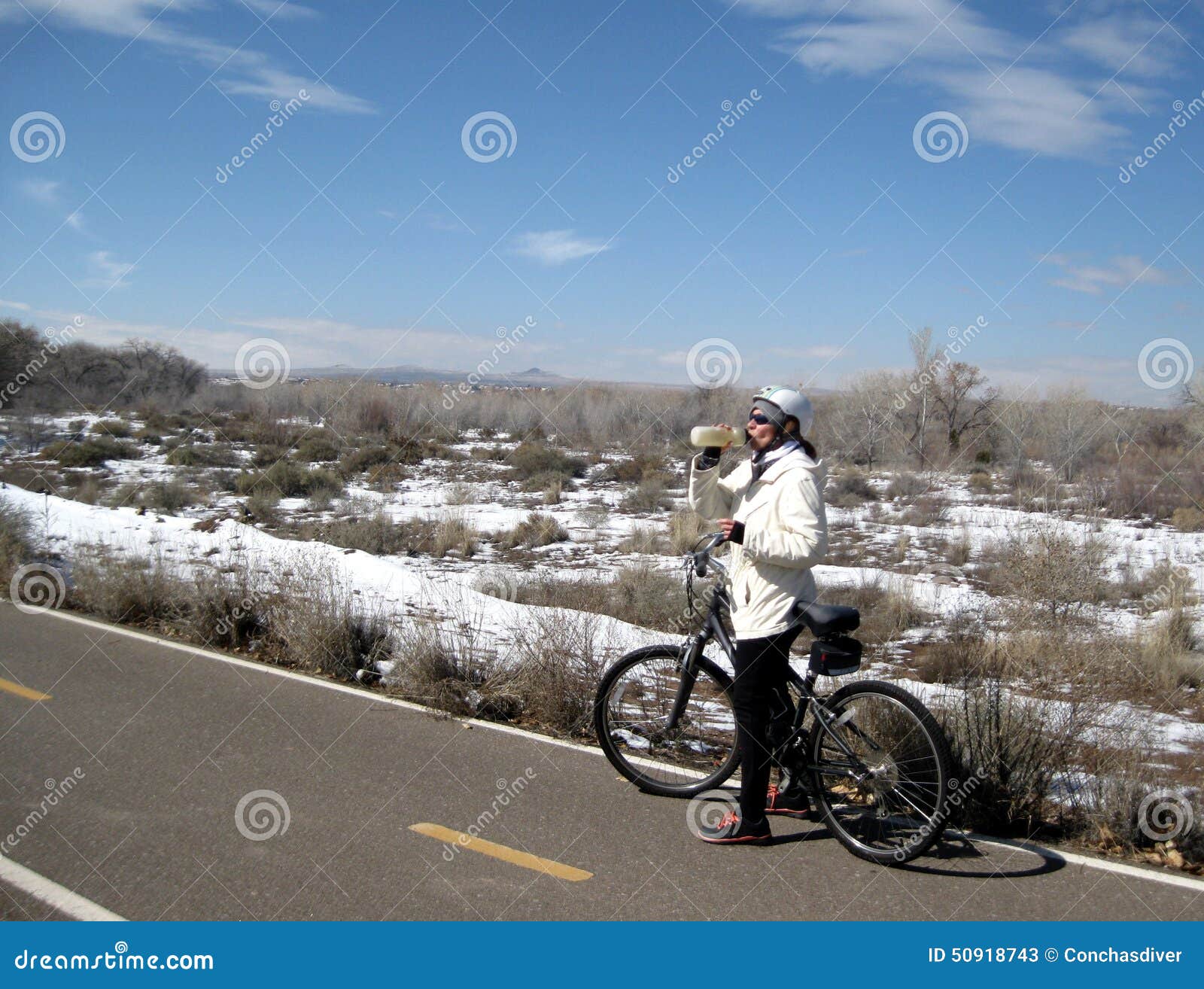 winter bike ride female mountain biker braves cold weather to trail middle albuquerque nm usa 50918743