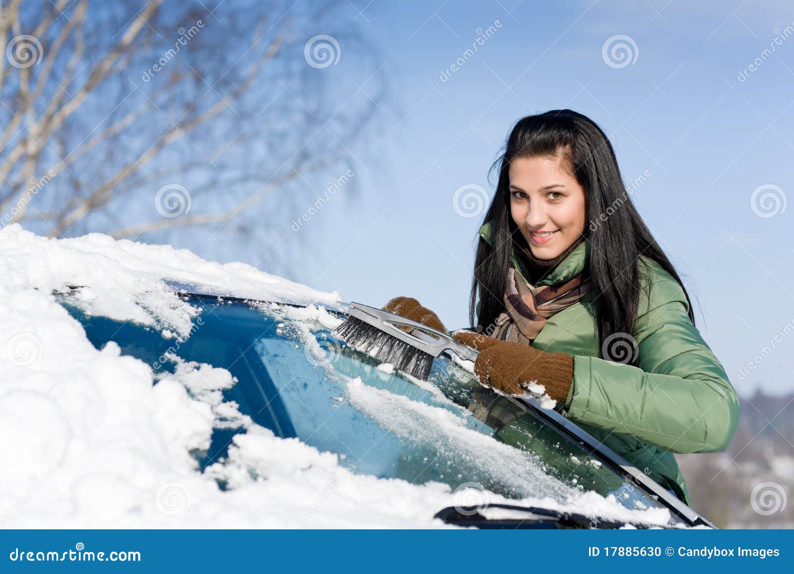 winter car - woman remove snow from windshield