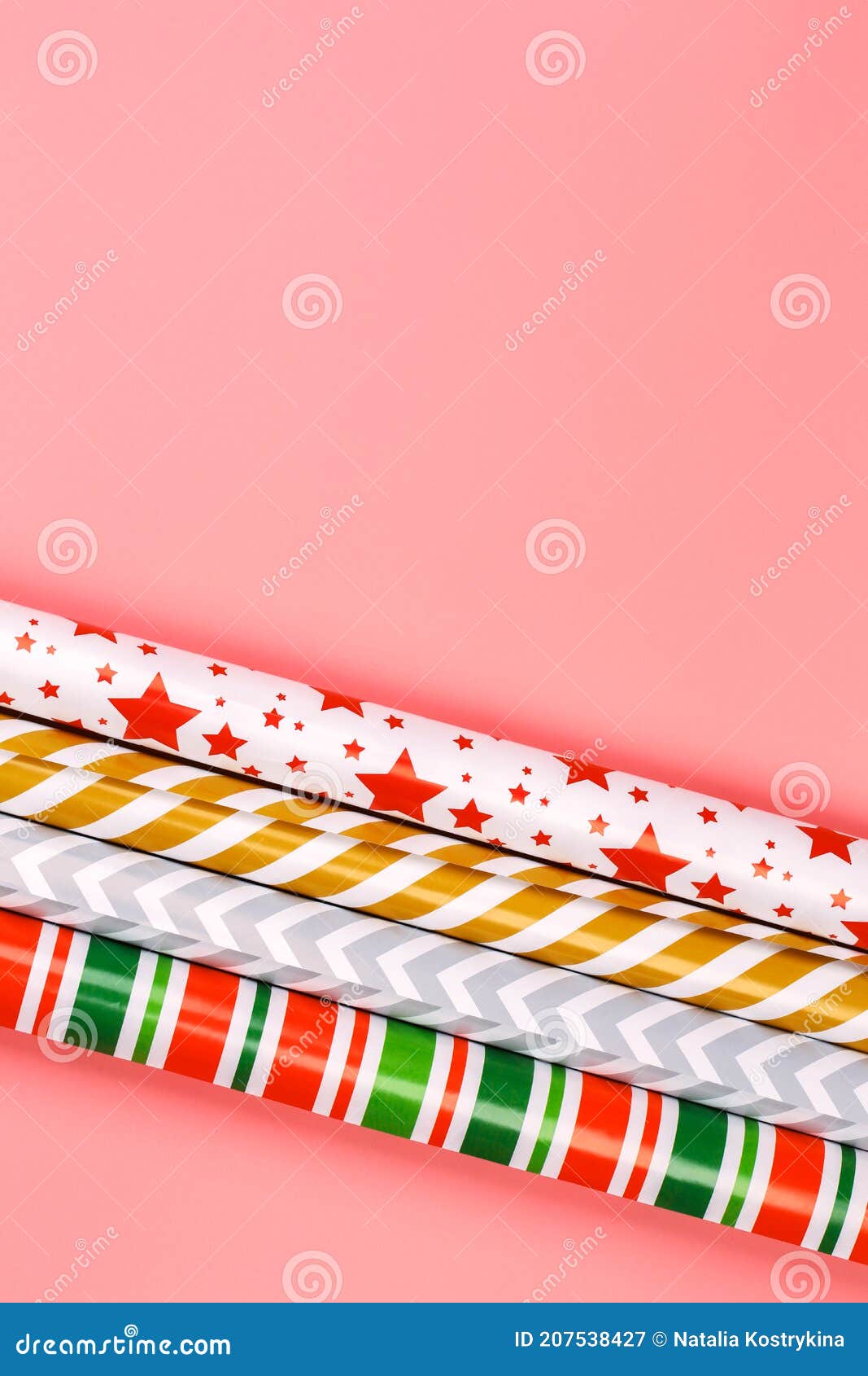 winter creative layot. gift wrapping paper on a pink background. minimalistic christmas scandy background with empty place for