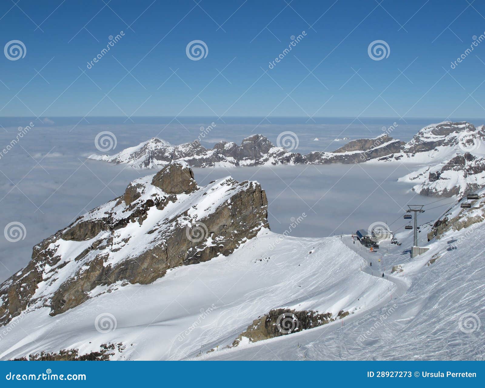 Winter day on the Titlis, Chair lift, sea of fog and mountains. Lucerne Canton.