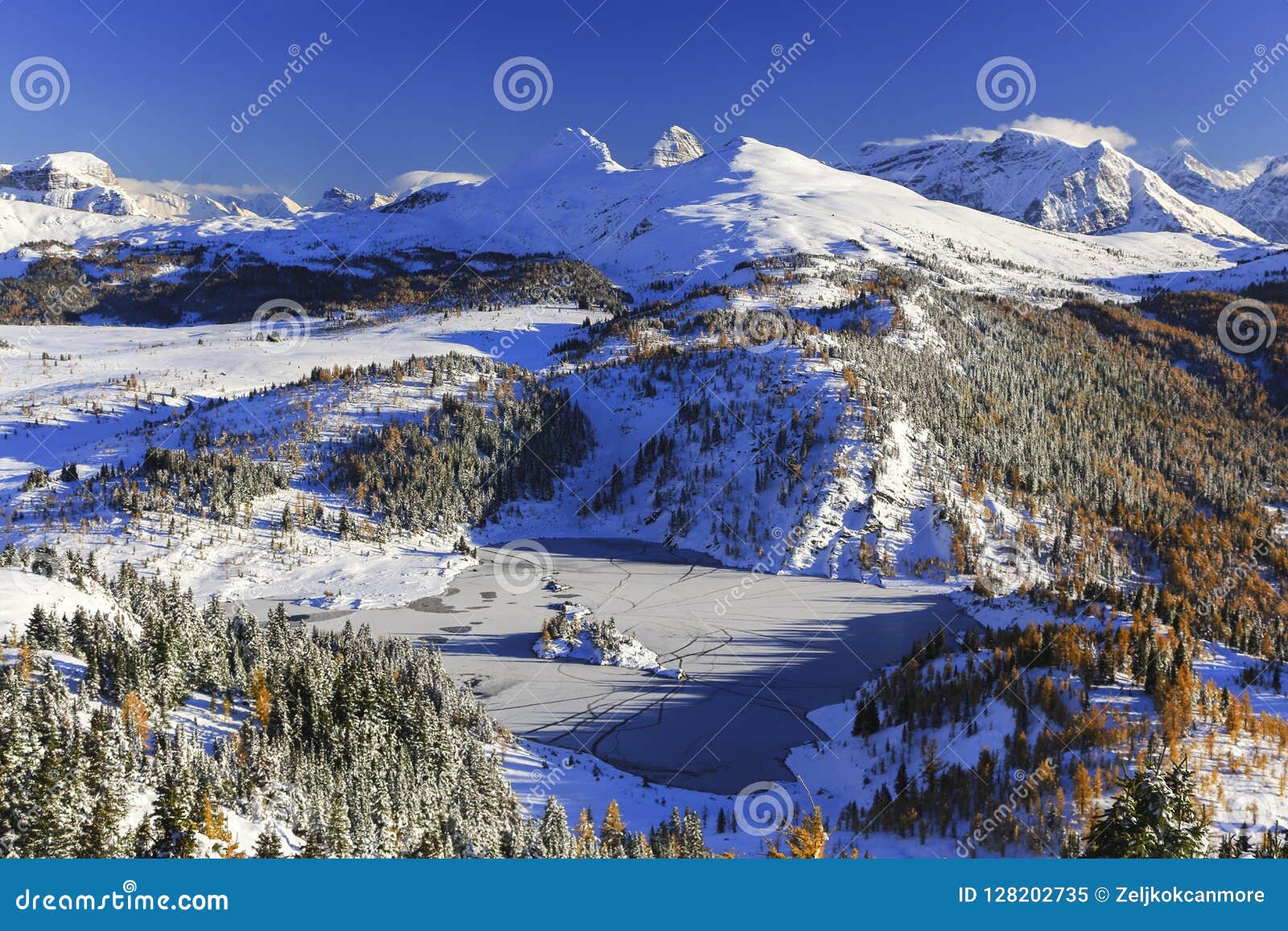 winter landscape frozen lake snow distant mountain peaks banff national park