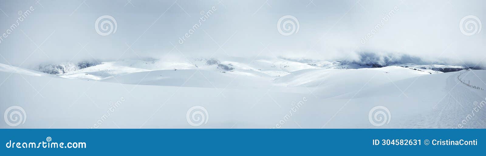 winter landscape of snow-capped mountains with a surreal blue-white atmosphere