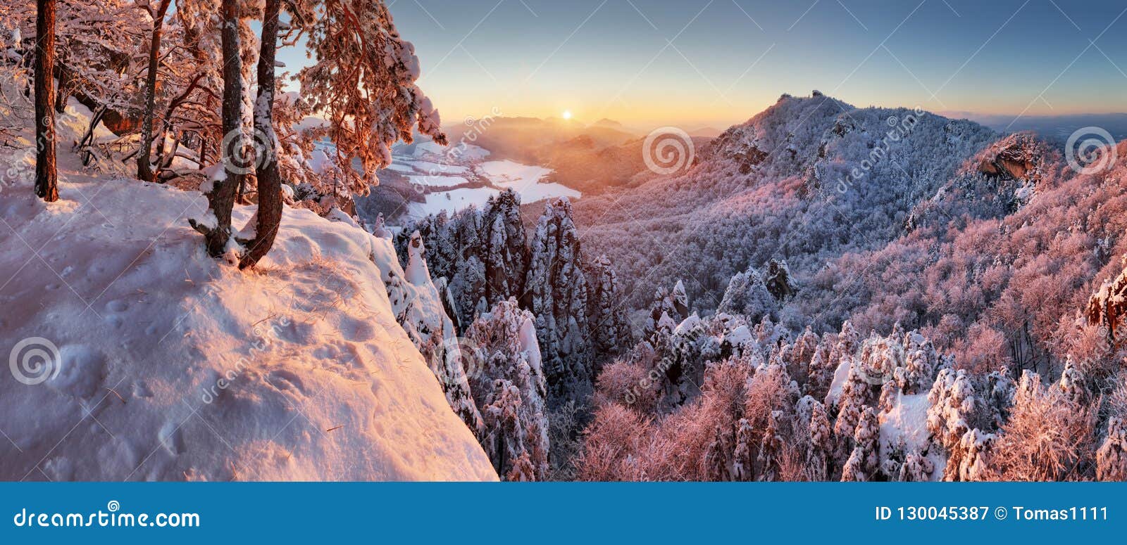 winter mountain landcape with snow forest at sunset