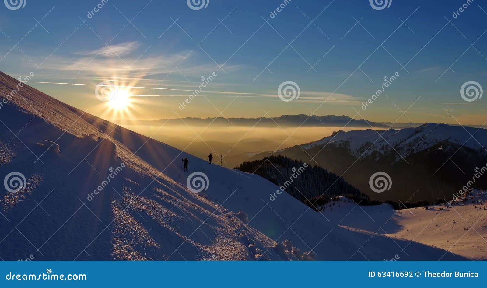 splendid sunset. winter mountain landscape. sun, snow and hikers at high altitude - ciucas mountains, landmark attraction, romania