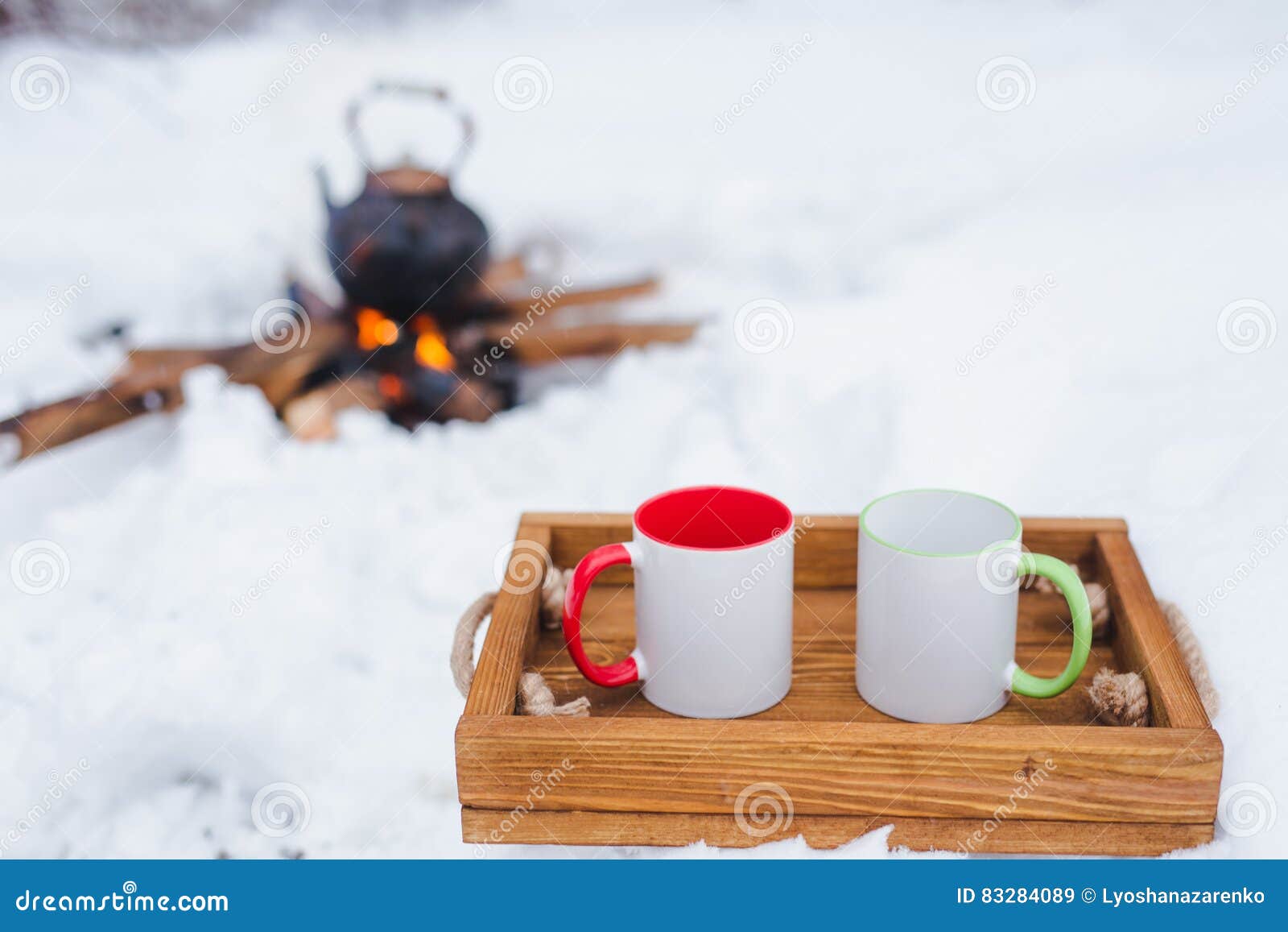 Copper kettle over an open fire in winter. Boiling kettle on