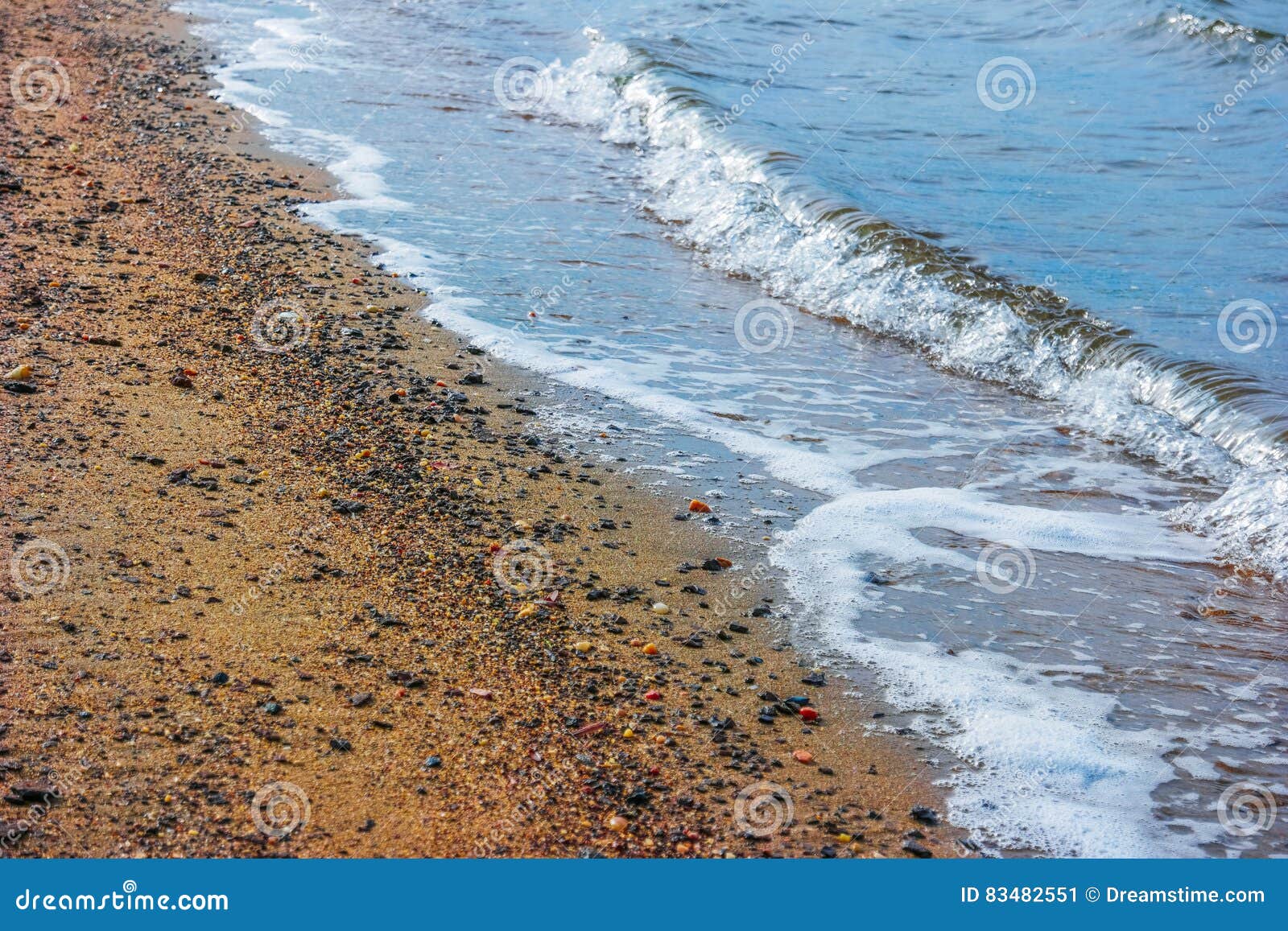 A Winter Scene of the Bay and Sandy Shoreline and Waves at Ebbtide