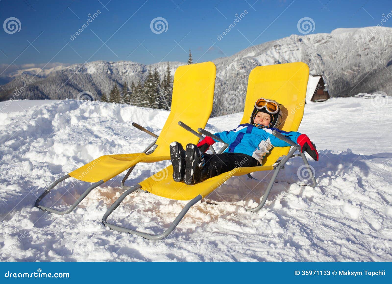 Winter, ski, sun and fun. Winter, ski, sun and fun - happy boy skier in winter resort resting in the deck chair