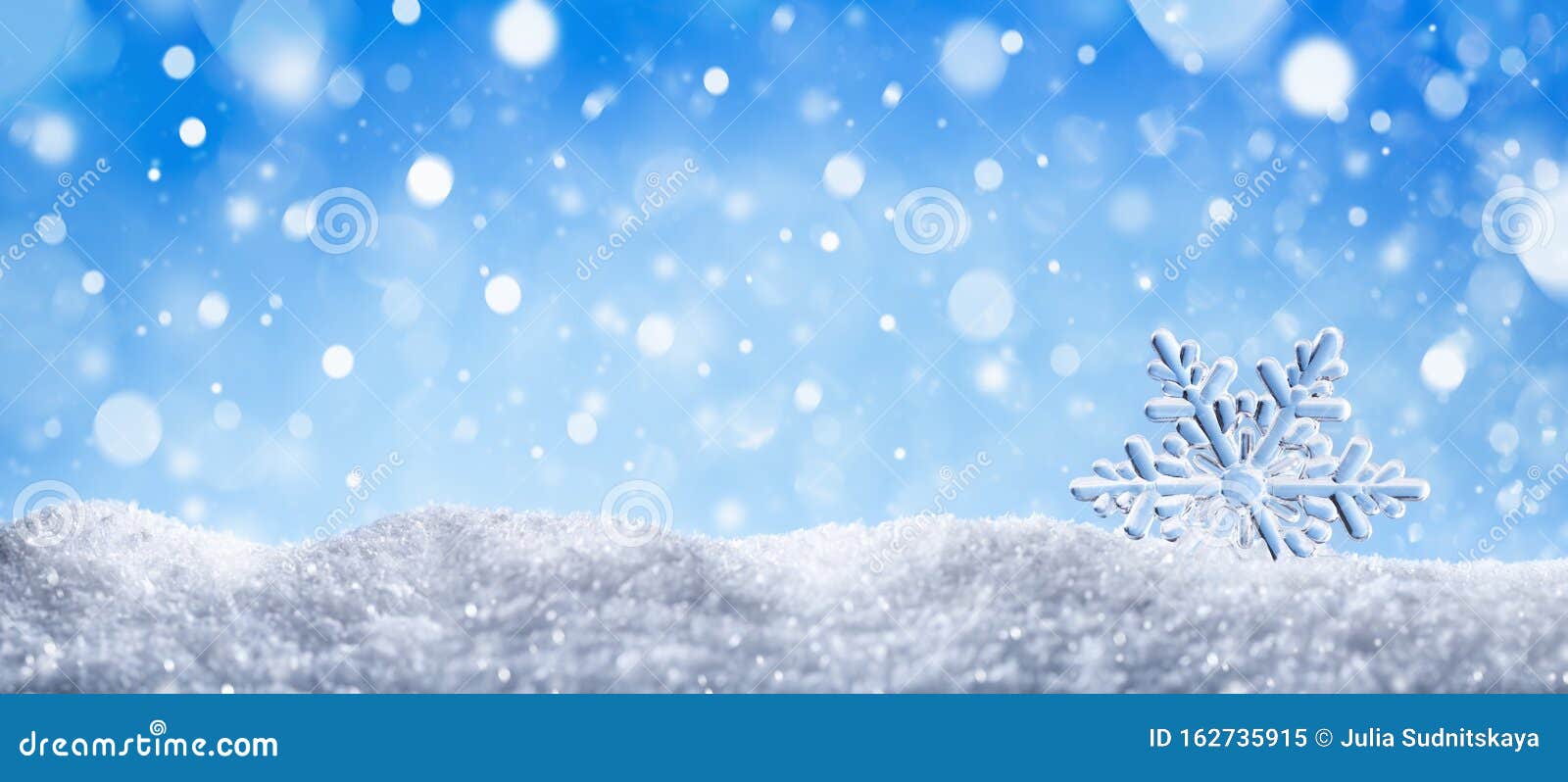 winter snow background with decorative snowflake against blue sky. banner format. beautiful wintertime holiday scene