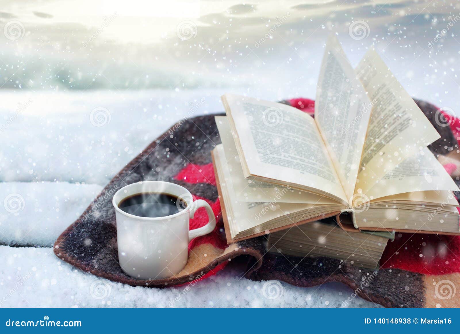 winter still life: cup of coffee and opened book