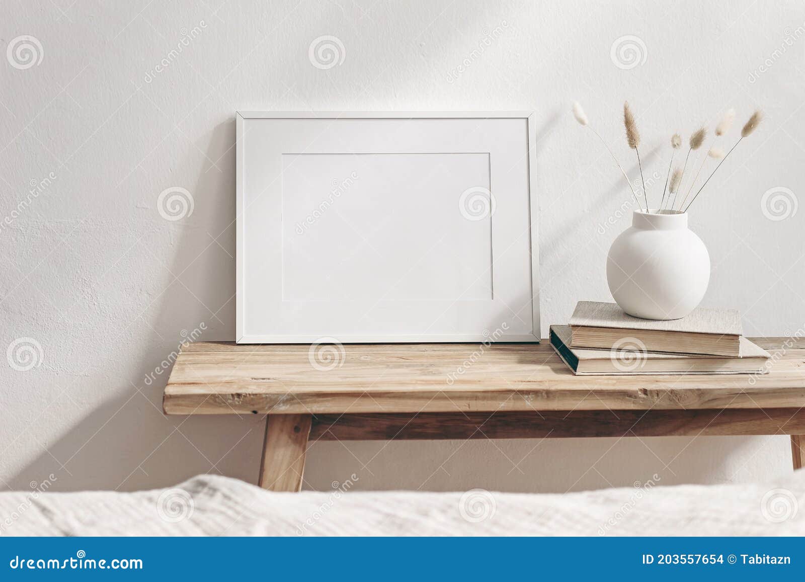 winter still life. horizontal white frame mockup on vintage wooden bench, table. modern white ceramic vase with pine