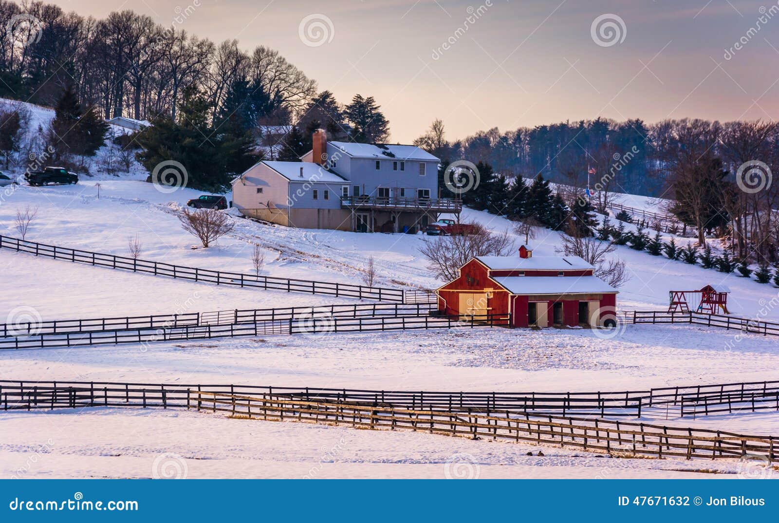 winter view of a house and barn on farm in rural carroll county, maryland.