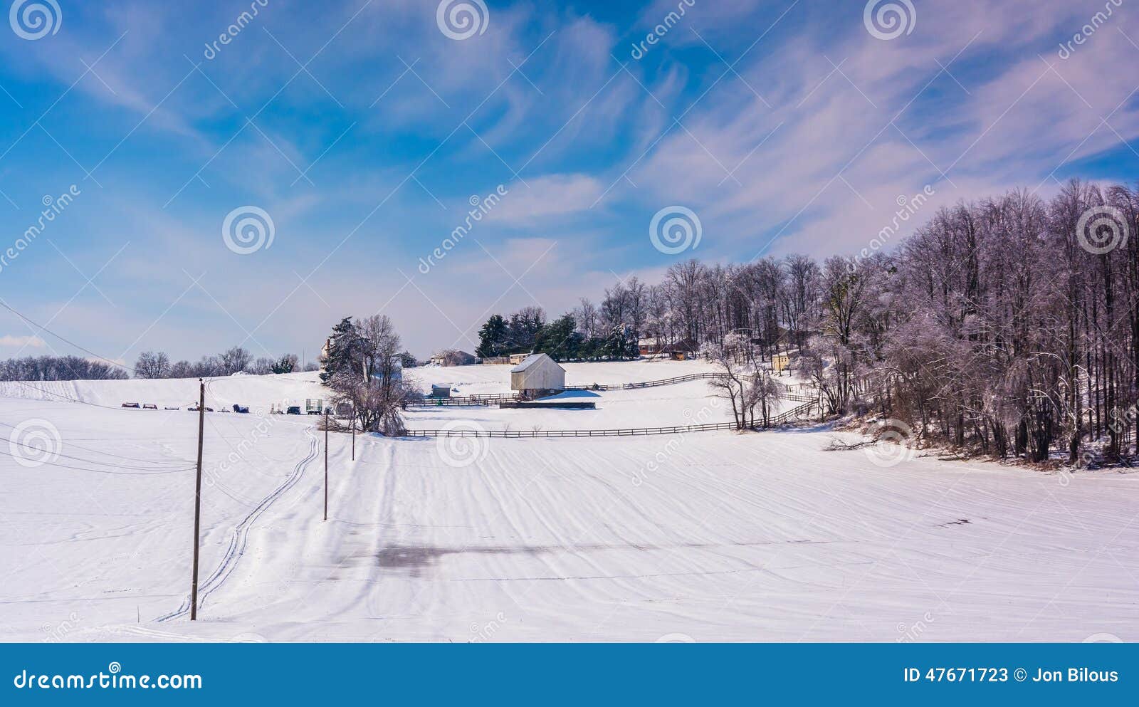 winter view of snow covered farm fields in rural carroll county, maryland.
