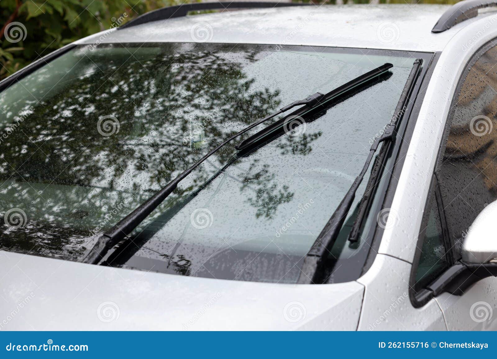 Wipers Cleaning Raindrops from Car Windshield Outdoors Stock Photo