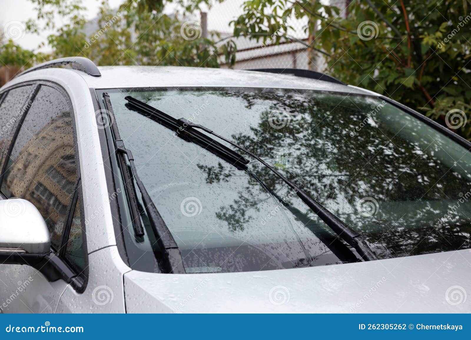 Wipers Cleaning Raindrops from Car Windshield Outdoors Stock Photo