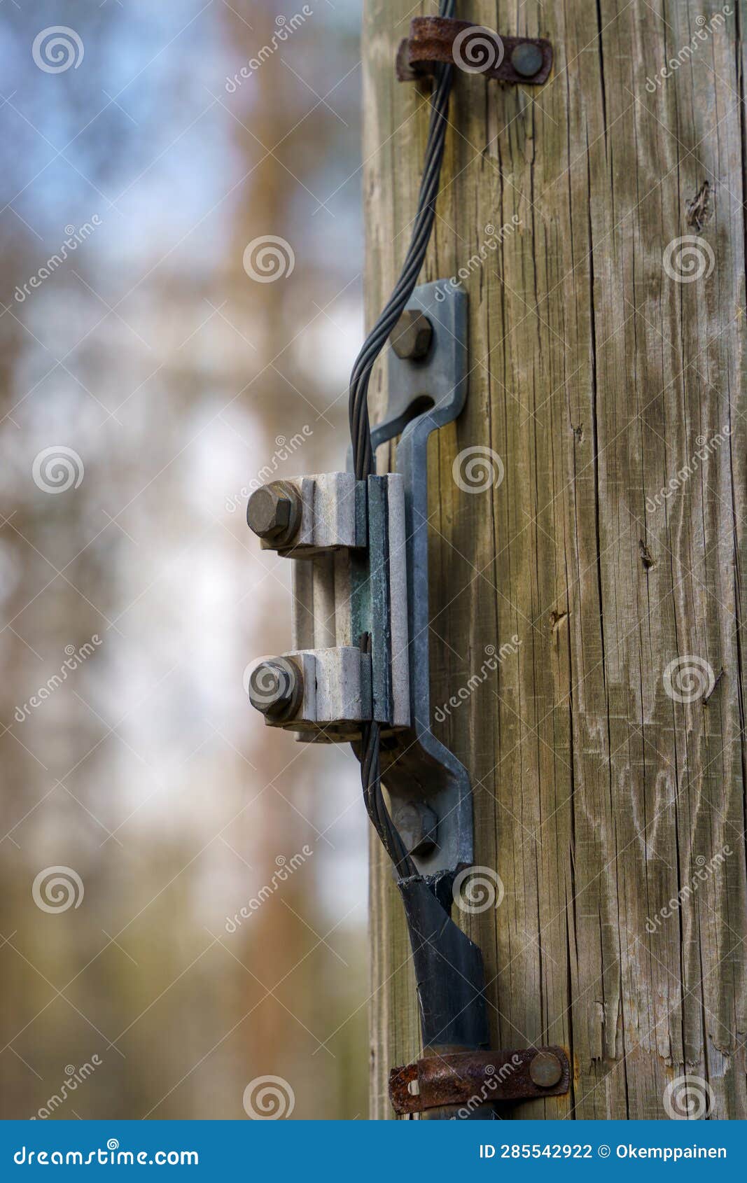 Wire Connector for Ground Wire on a Wooden Electric Pole Outdoors Stock
