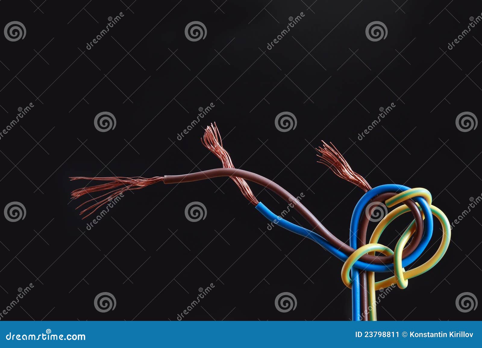 Abstract composition with knotted colored wire on dark background