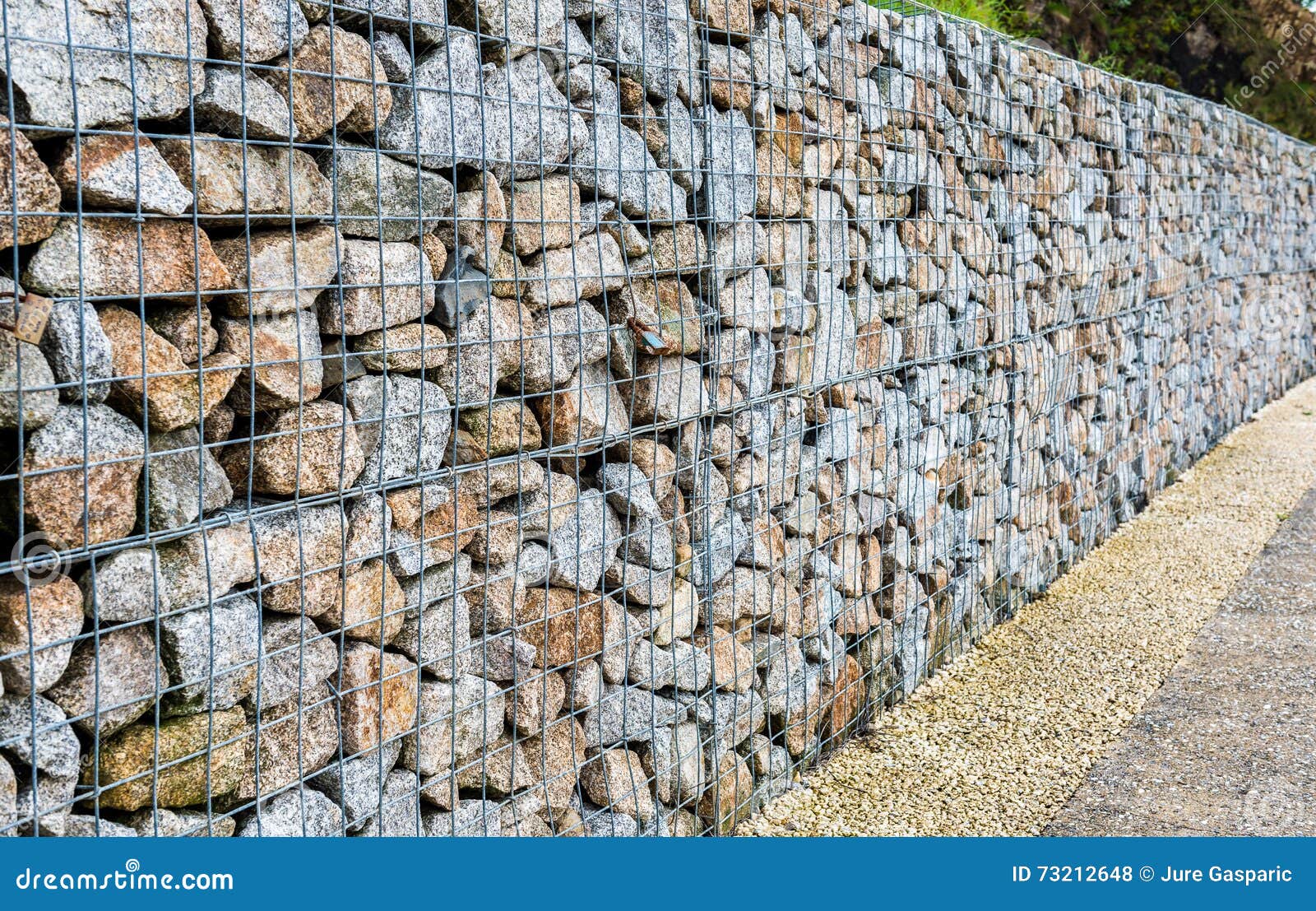 wire gabion rock fence. metal cage filled with rocks.