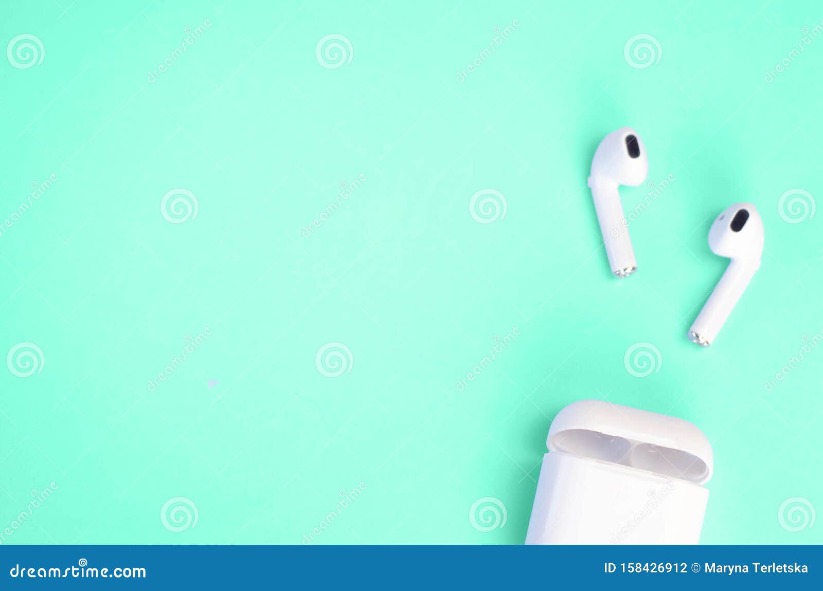 Wireless White Headphones with a Case on a Mint Background Stock Photo