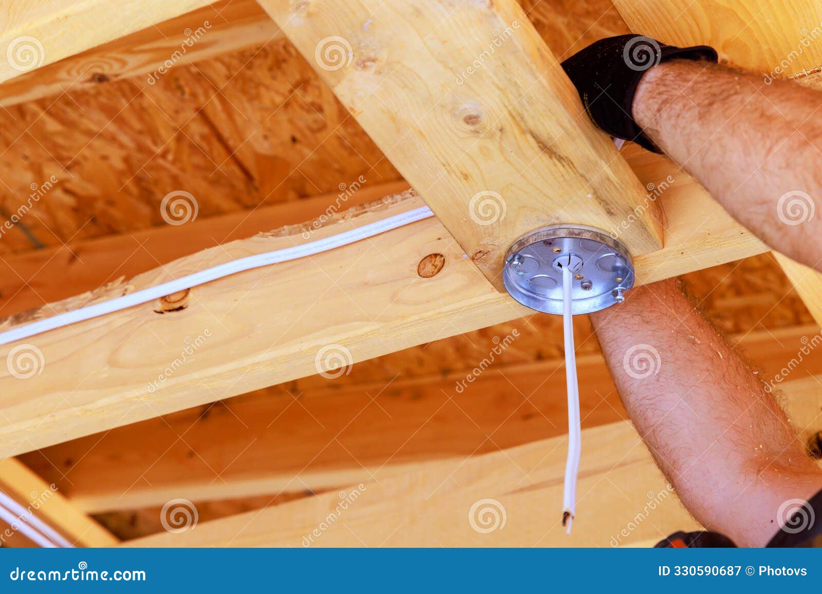 Wiring for a Ceiling Light Lamp is Mounted by an Electrician Inside an
