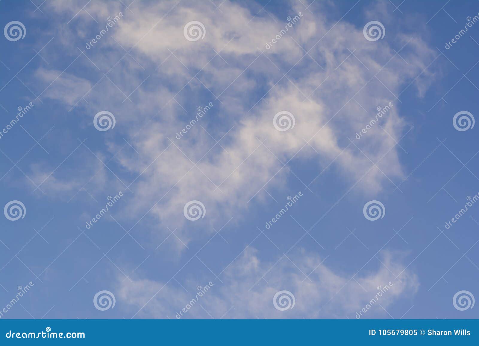 Wispy White Clouds Against a Blue Sky. Background Suitable Stock Image