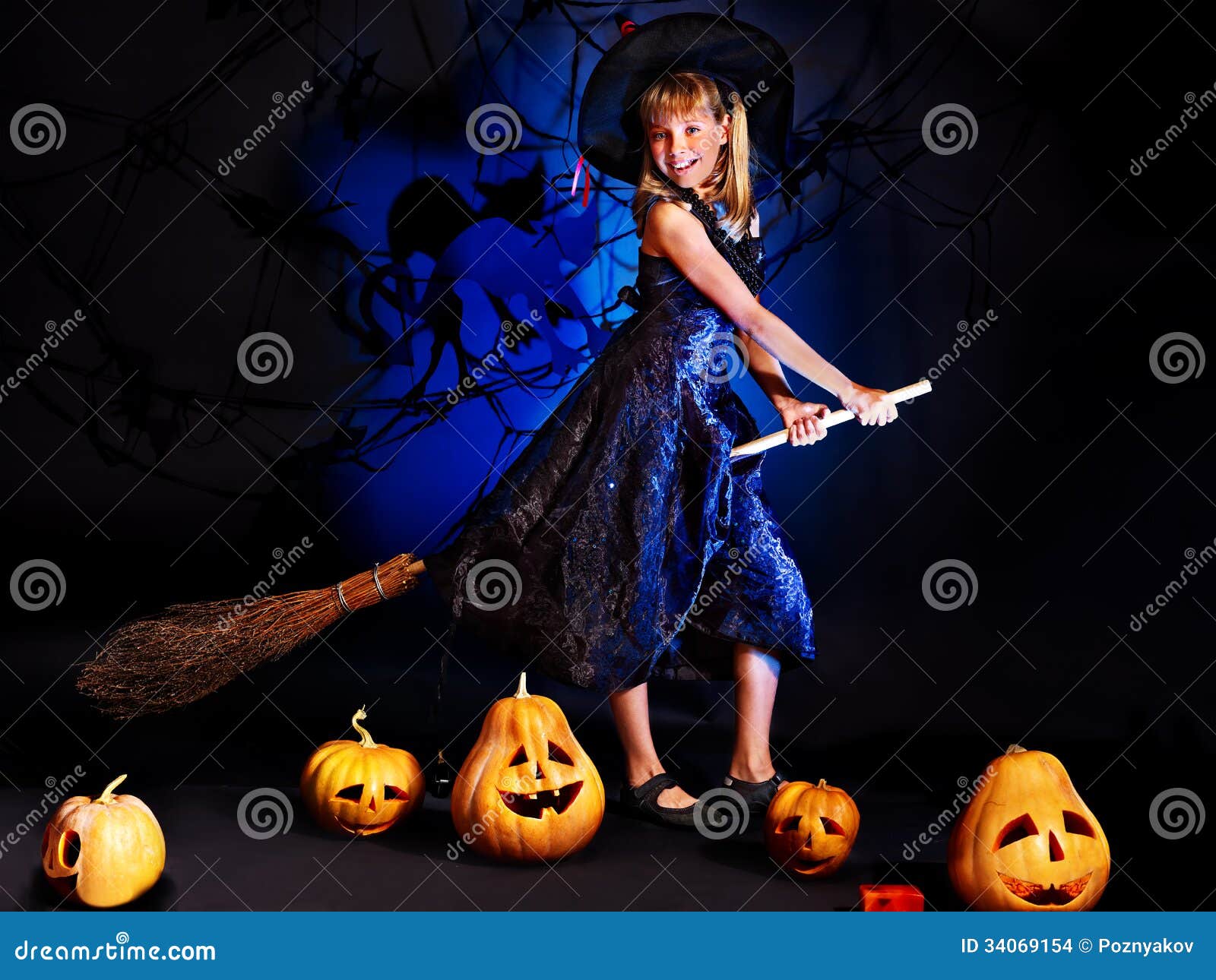 Premium Photo  Funny baby boy in halloween witch costume with pumpkin jack  and broom indoors