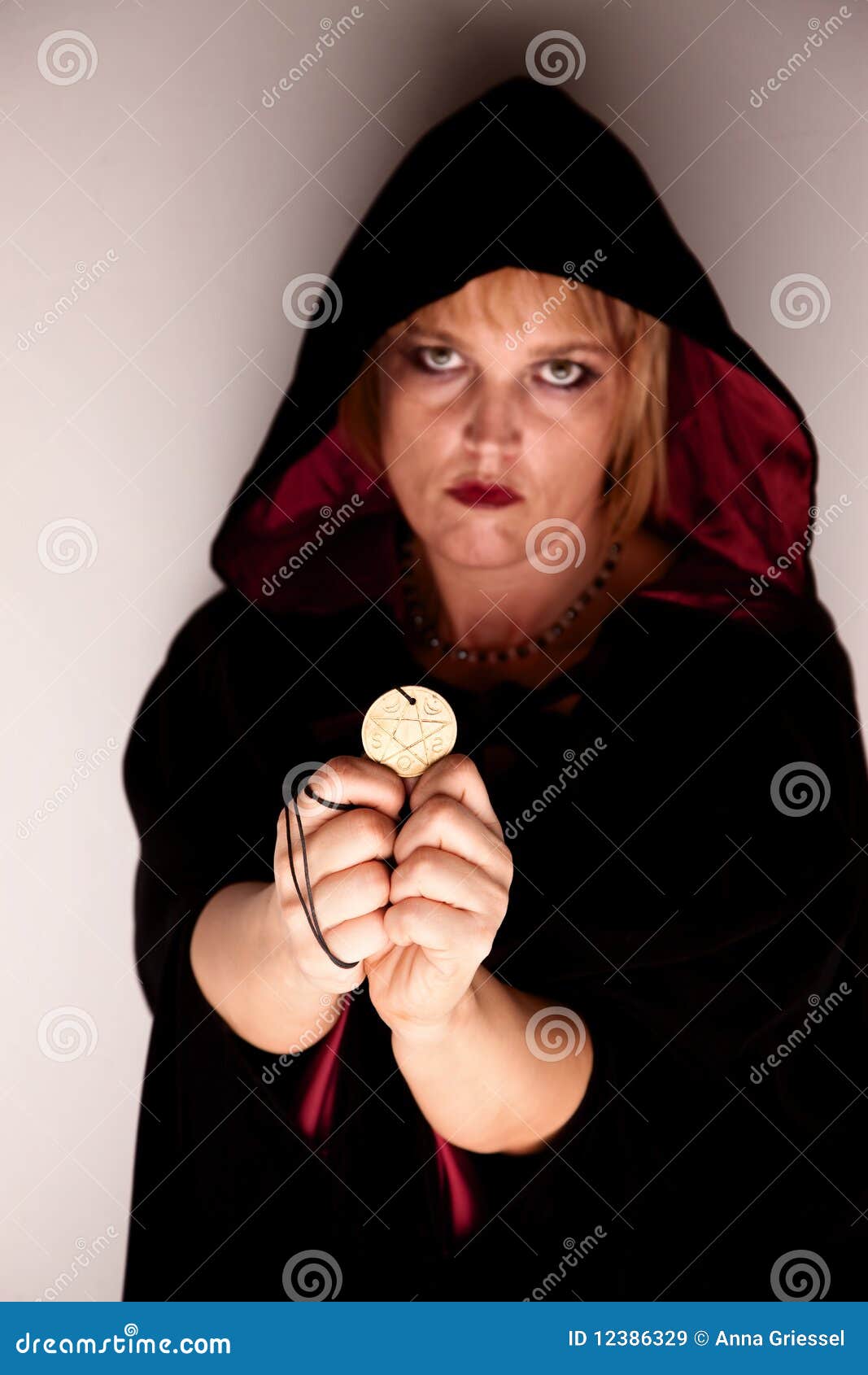 witch in a corner with talisman